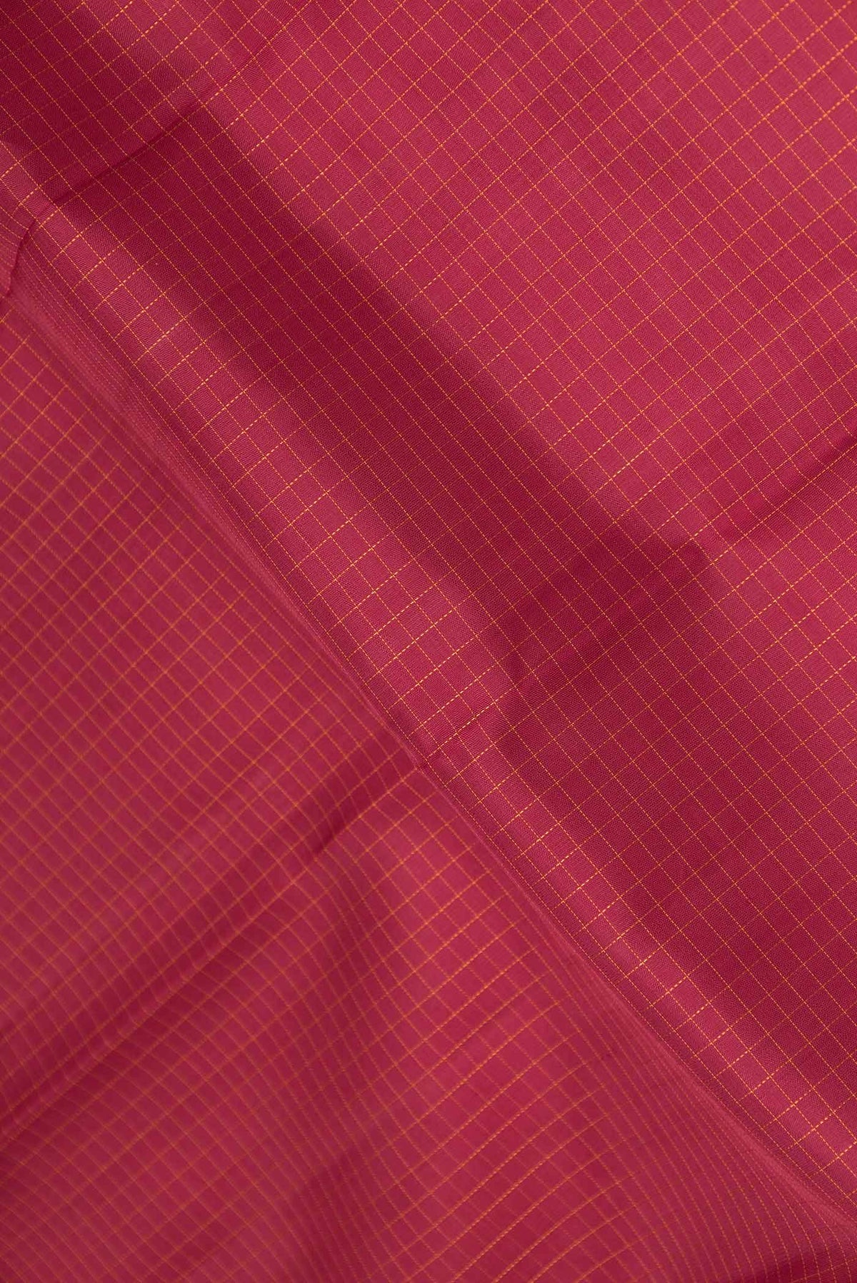 Close up of Maroon Dual Tone Kanchipuram Silk Saree with Checked design on the body and Zari Border displaying folds