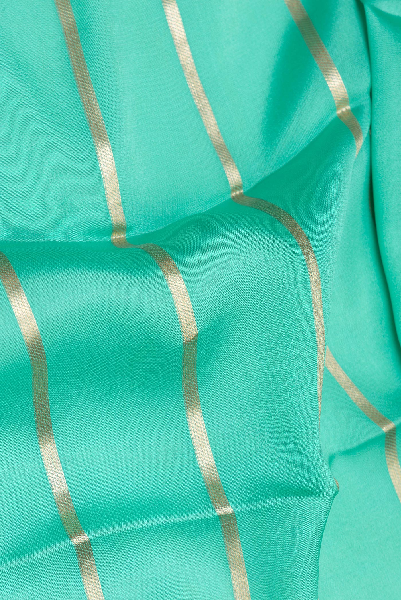 Close up of Sea Green Mysore Silk Saree with Stripes on the body and Fancy Border.  displaying folds