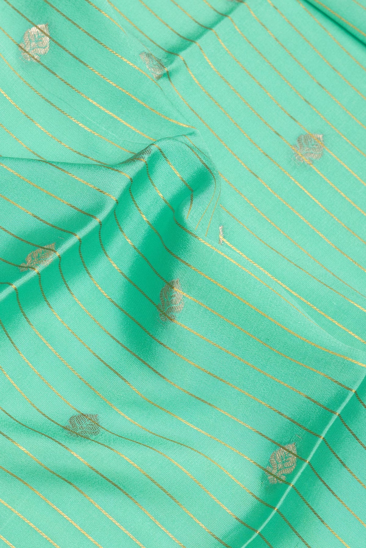 Close up of Sea Green Mysore Crepe Saree with Stripes on the body and Zari Border.  displaying folds