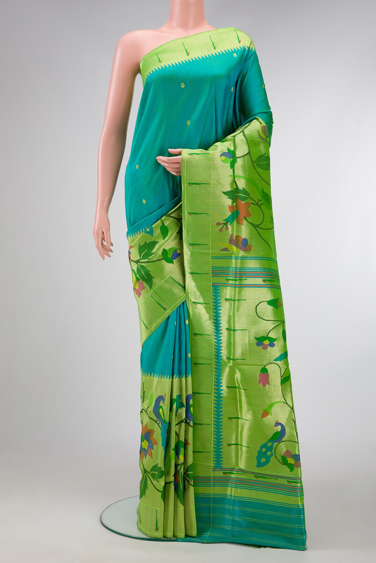 Peacock Blue Dual Tone Paithani Silk Saree with Zari Butta on the body and Paithani Border.  displayed on a mannequin