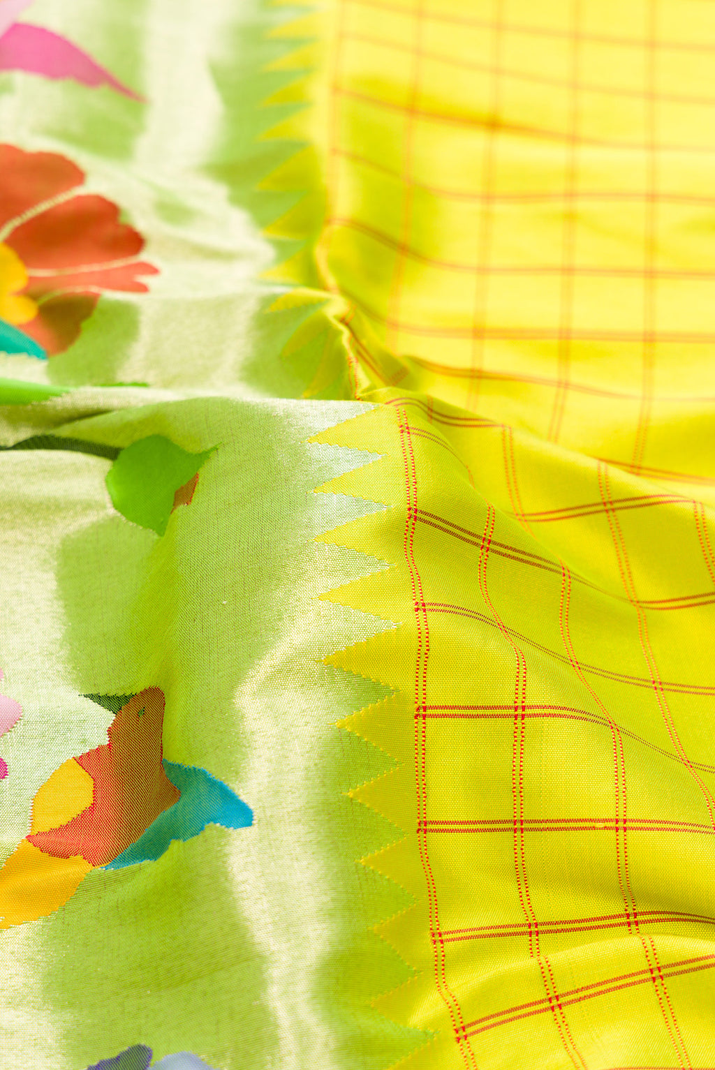 Close up of Parrot Green Dual Tone Paithani Silk Saree with Half And Half on the body and Without Border.  displaying folds