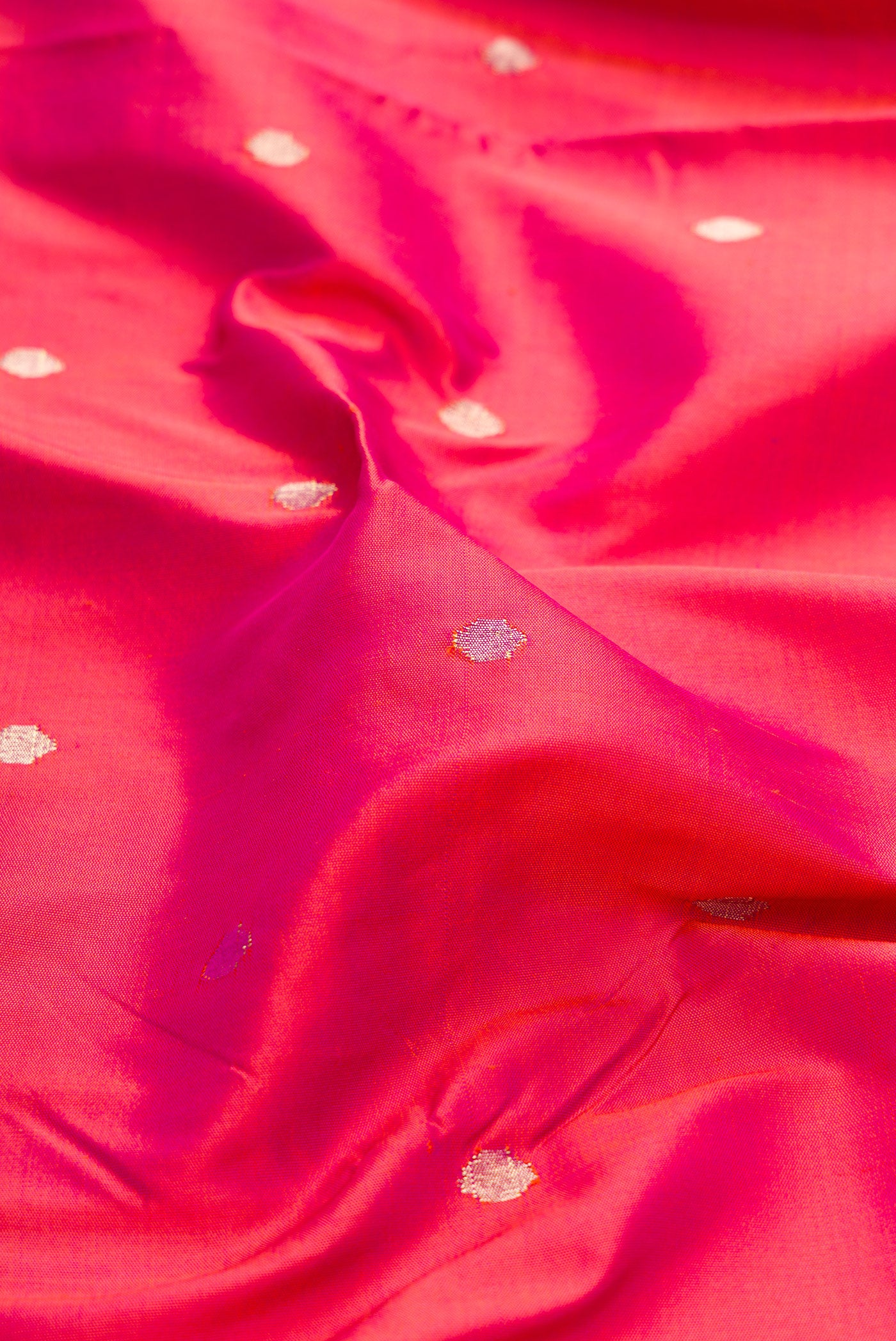 Close up of Pink Dual Tone Paithani Silk Saree with Zari Butta on the body and Paithani Border.  displaying folds