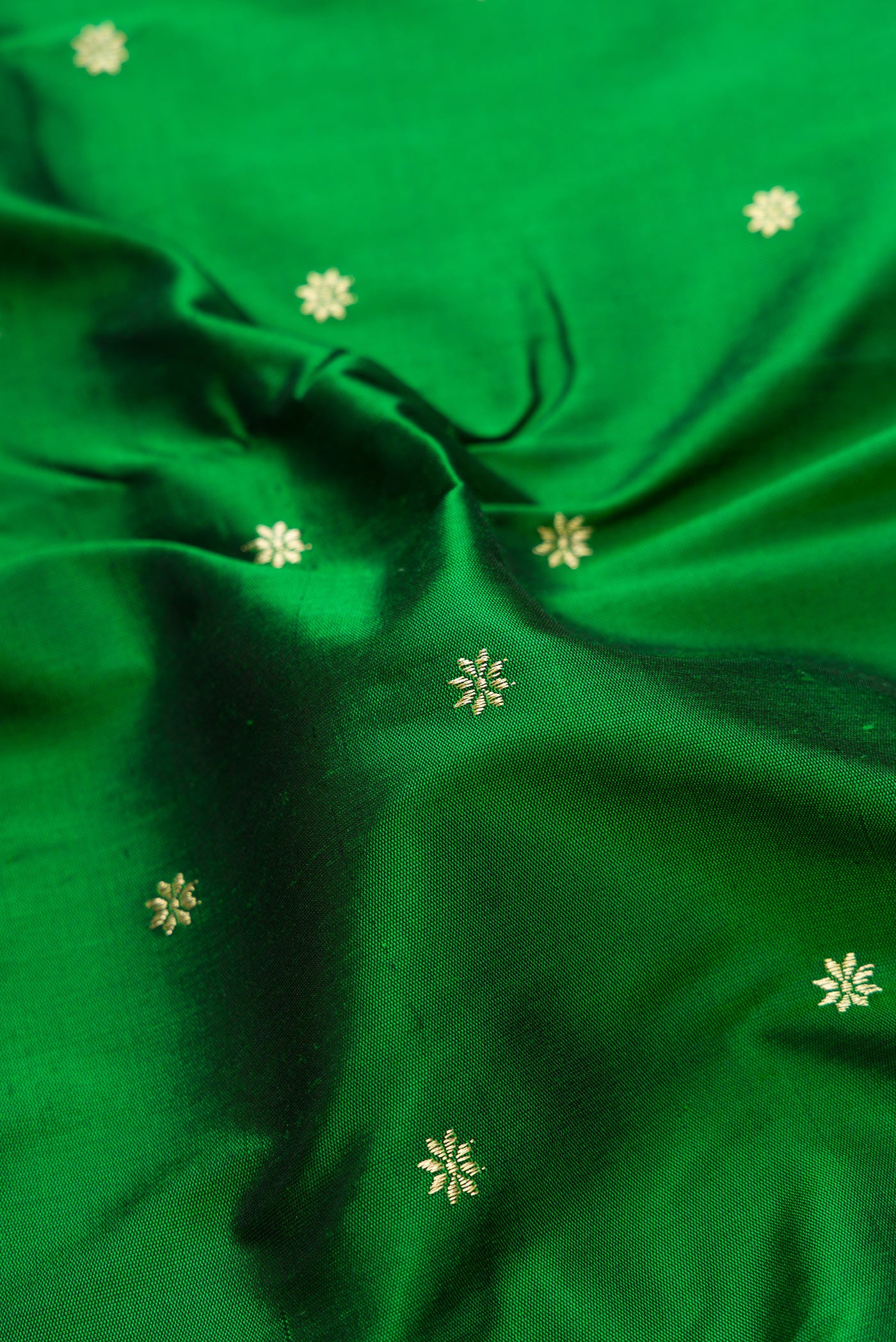 Close up of Bottle Green Dual Tone Paithani Silk Saree with Zari Butta on the body and Paithani Border.  displaying folds