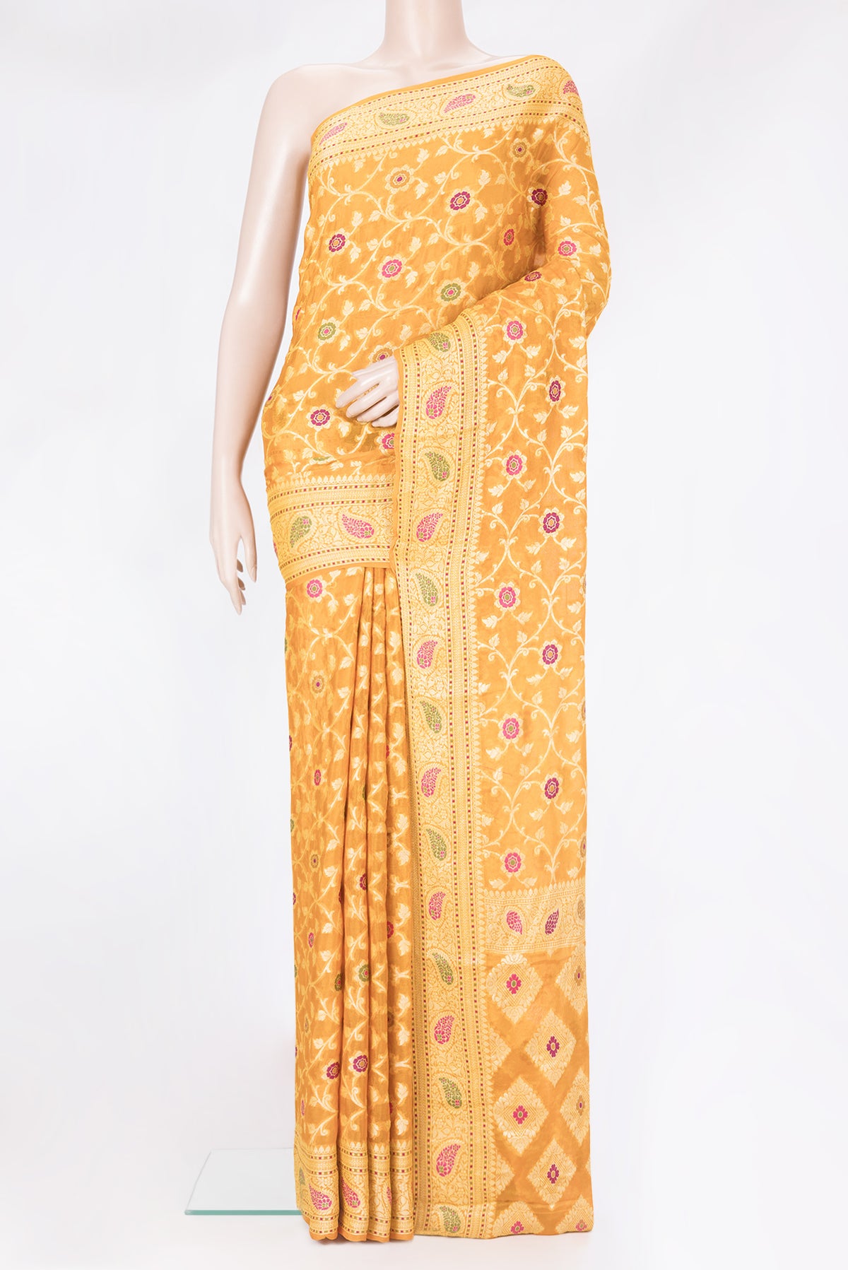 Mustard Banarasi Georgette Saree with Zari Brocade on the body and Zari And Thread Border.  displayed on a mannequin