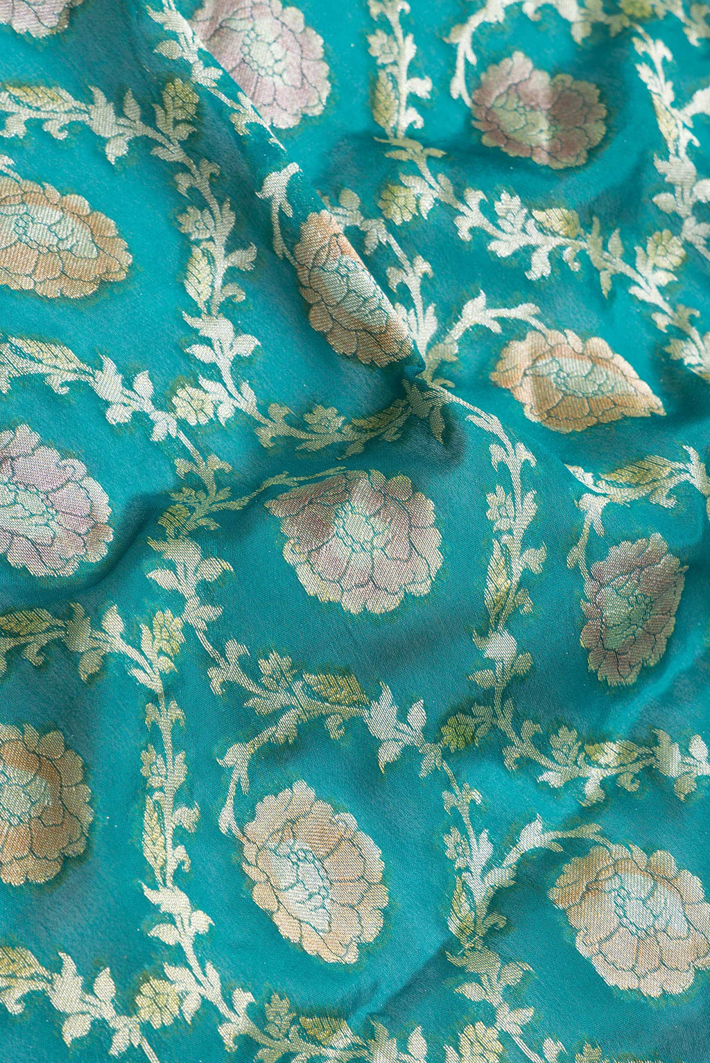 Close up of Peacock Blue Dual Tone Mysore Georgette Saree with Zari Brocade on the body and Thread Border.  displaying folds