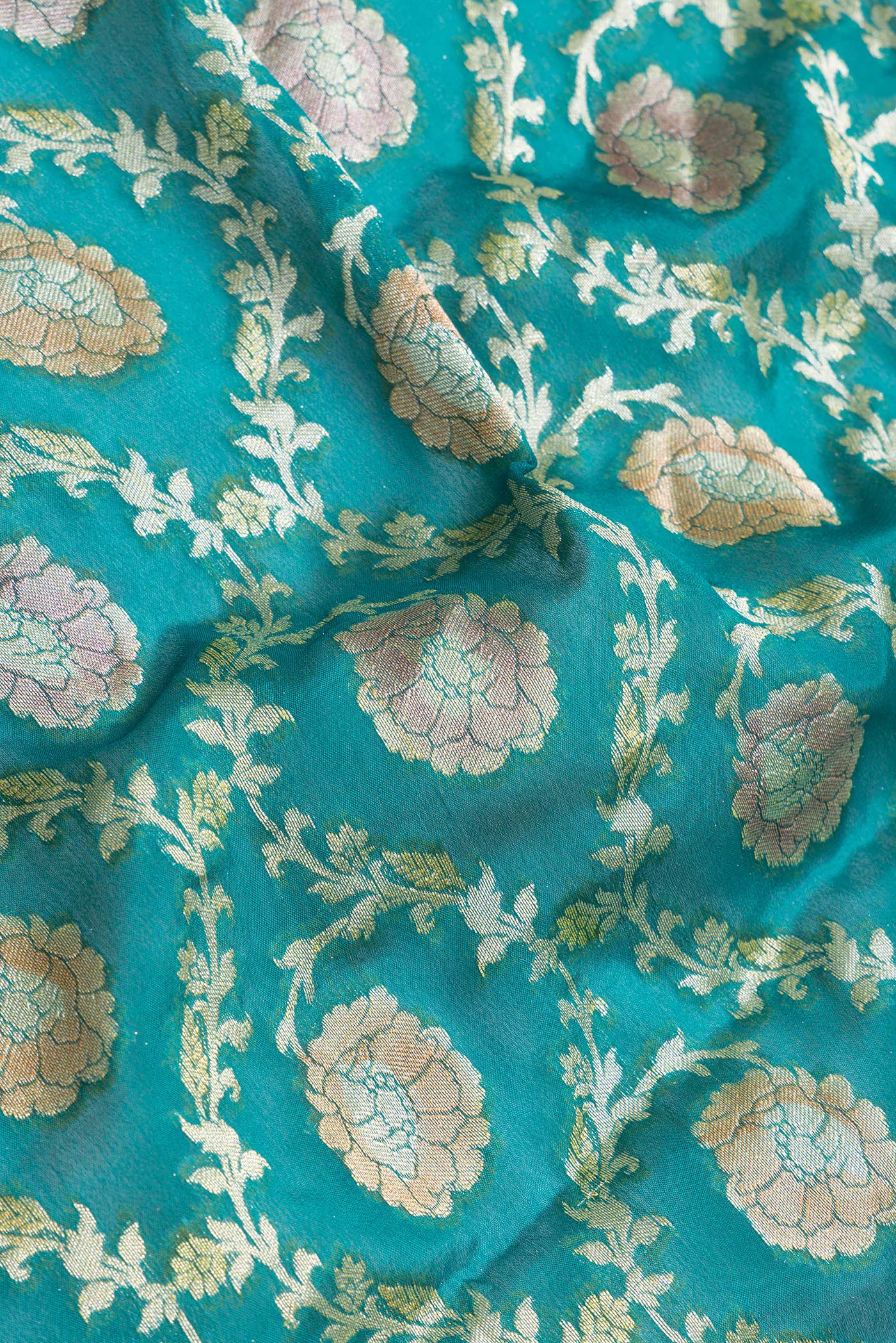 Close up of Peacock Blue Dual Tone Mysore Georgette Saree with Zari Brocade on the body and Thread Border.  displaying folds