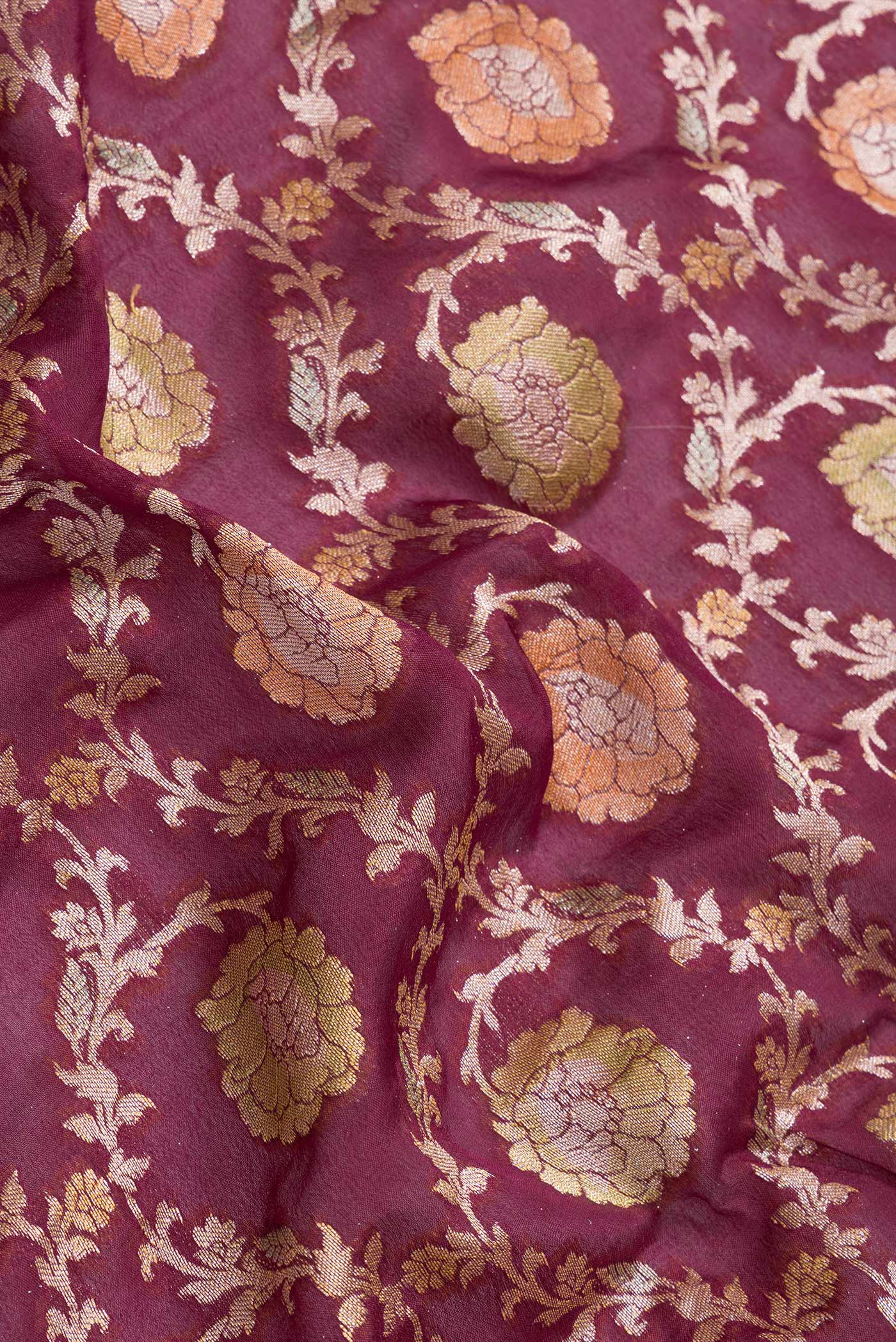 Close up of Maroon Dual Tone Mysore Georgette Saree with Zari Brocade on the body and Thread Border.  displaying folds