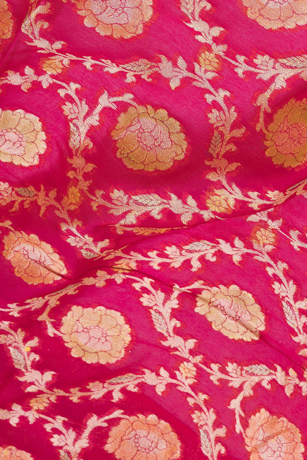 Close up of Pink Banarasi Georgette Saree with Zari Brocade on the body and Zari Border.  displaying folds