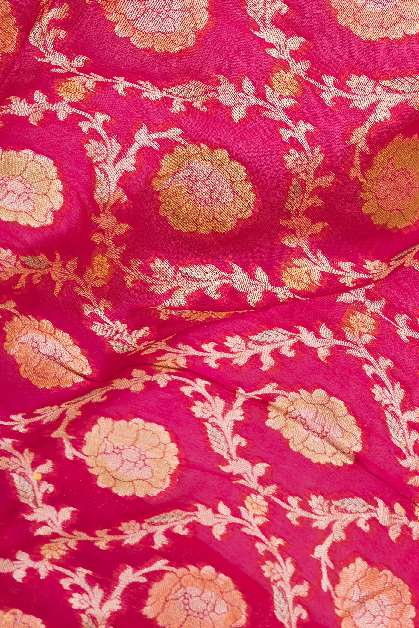Close up of Pink Banarasi Georgette Saree with Zari Brocade on the body and Zari Border.  displaying folds