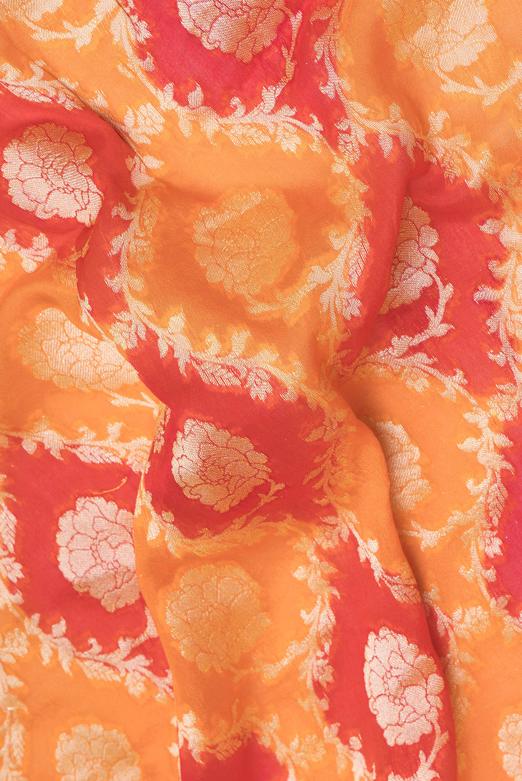 Close up of Orange Banarasi Georgette Saree with Zari Brocade on the body and Zari Border.  displaying folds