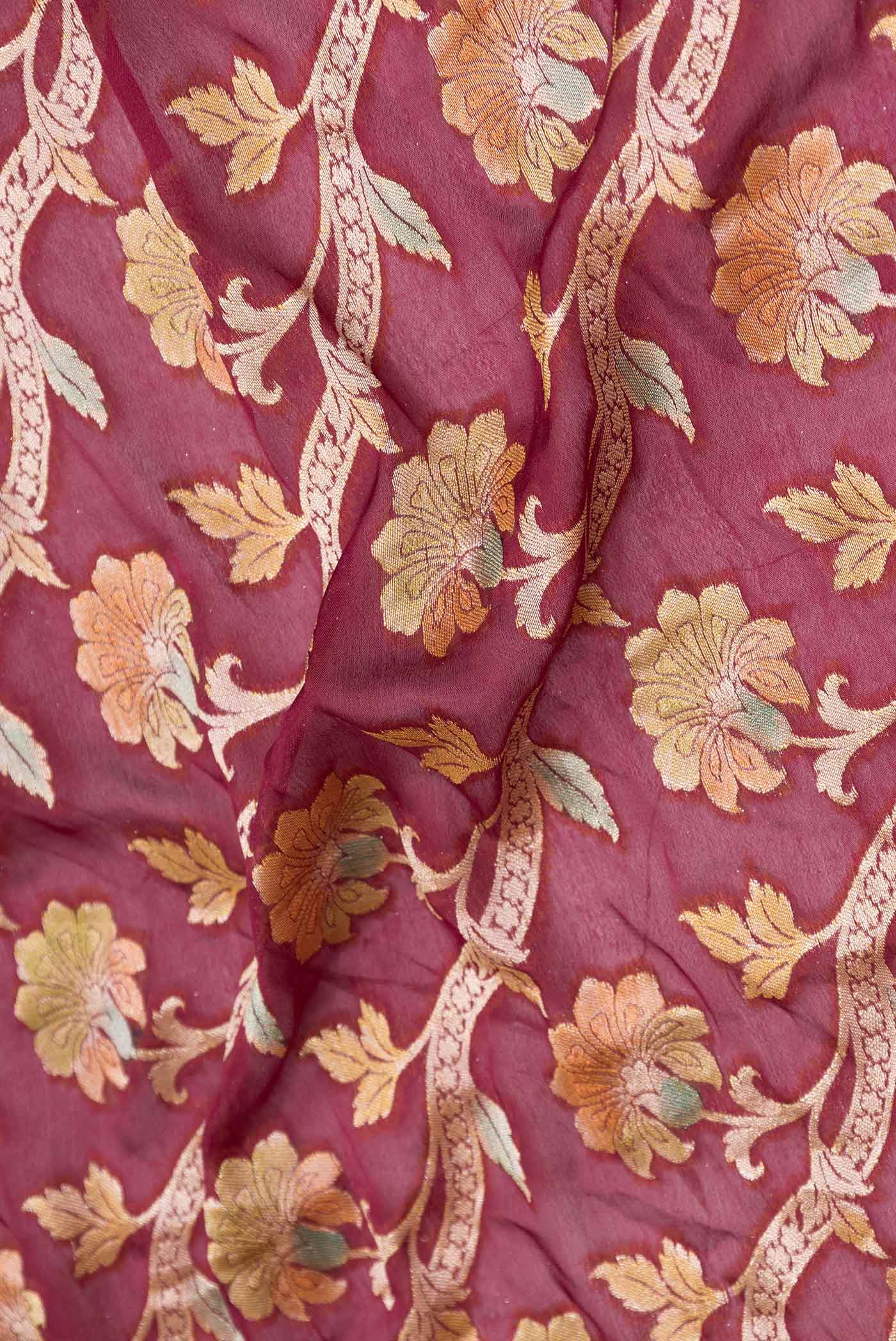Close up of Maroon Dual Tone Georgette Saree with Zari Brocade on the body and Zari Border displaying folds