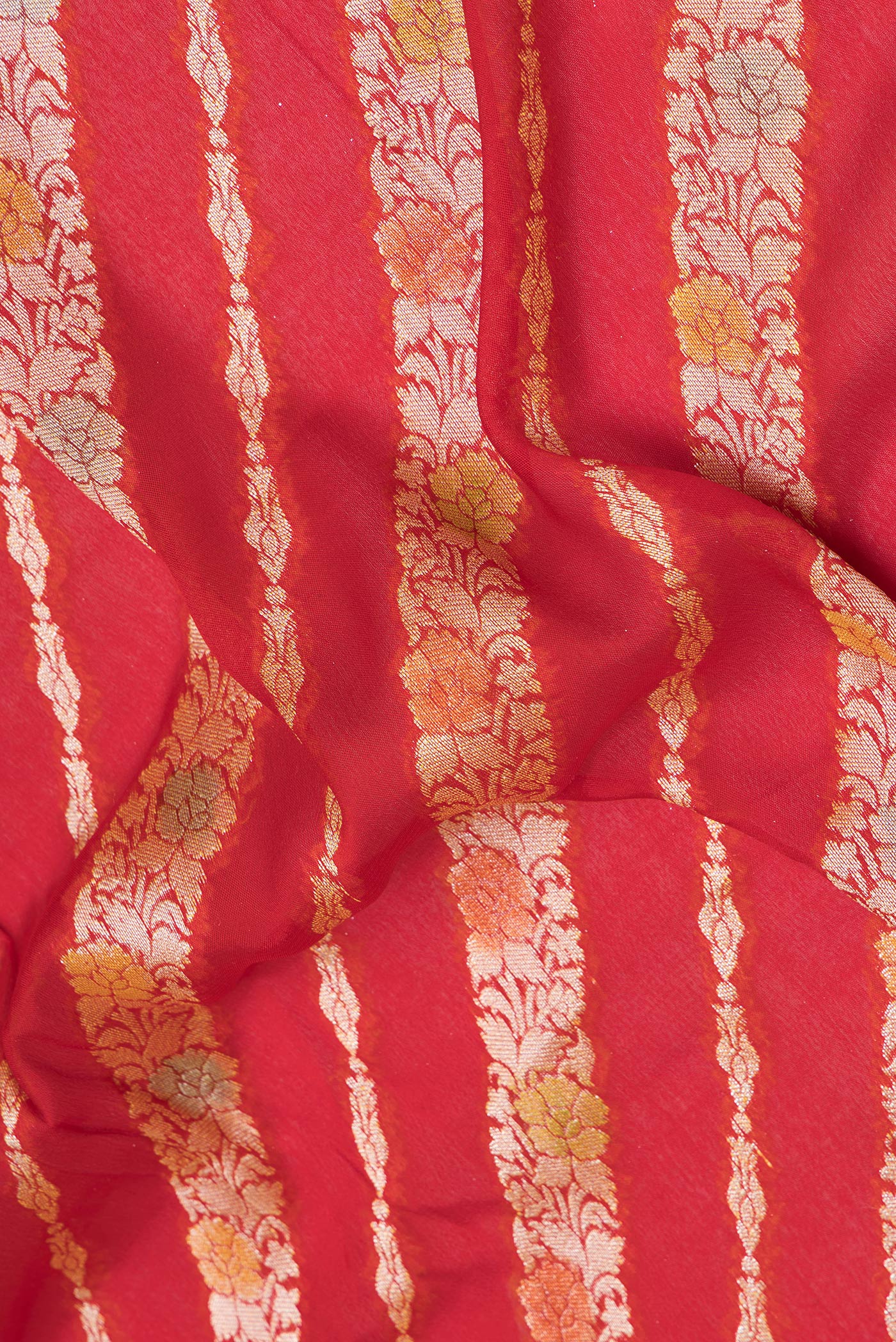 Close up of Red Banarasi Georgette Saree with Zari Brocade on the body and Zari Border.  displaying folds