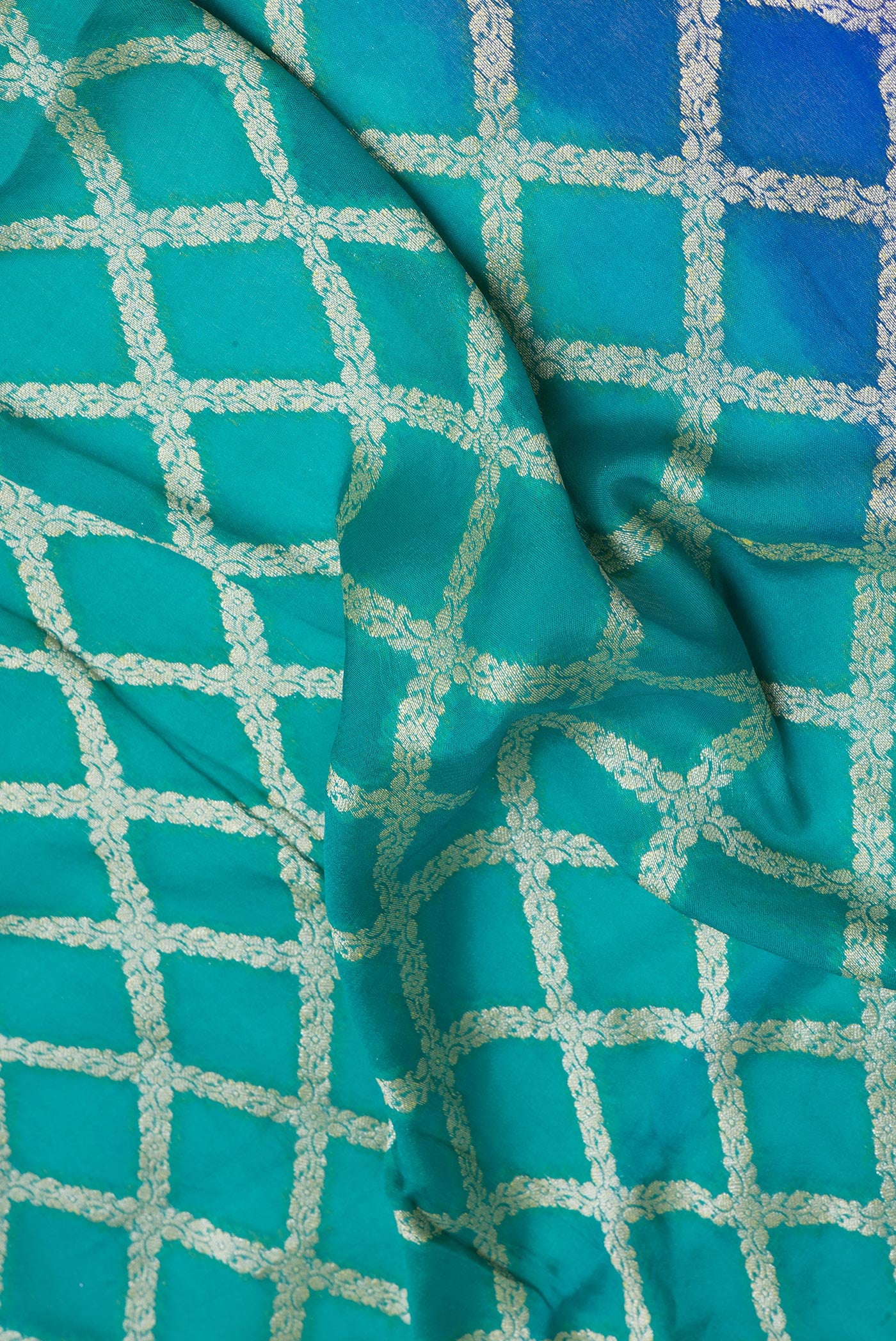 Close up of Peacock Blue Banarasi Georgette Saree with Zari Brocade on the body and Zari Border.  displaying folds