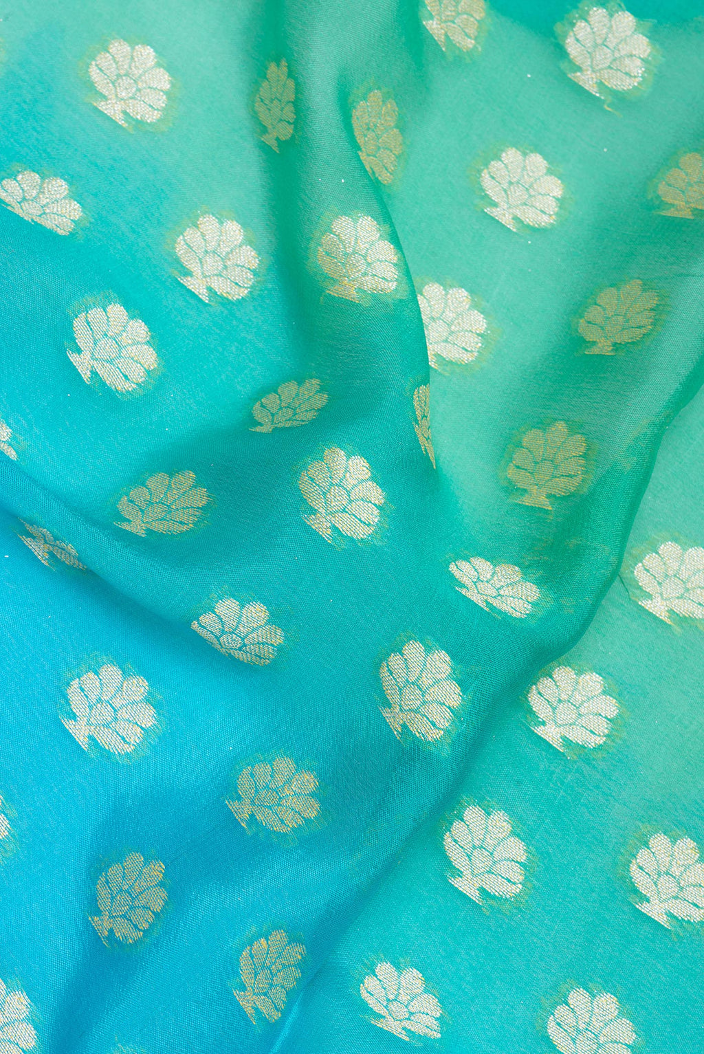 Close up of Sea Green Banarasi Georgette Saree with Zari Brocade on the body and Zari Border.  displaying folds
