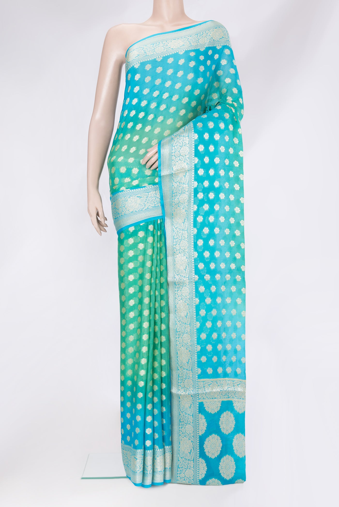 Sea Green Banarasi Georgette Saree with Zari Brocade on the body and Zari Border.  displayed on a mannequin