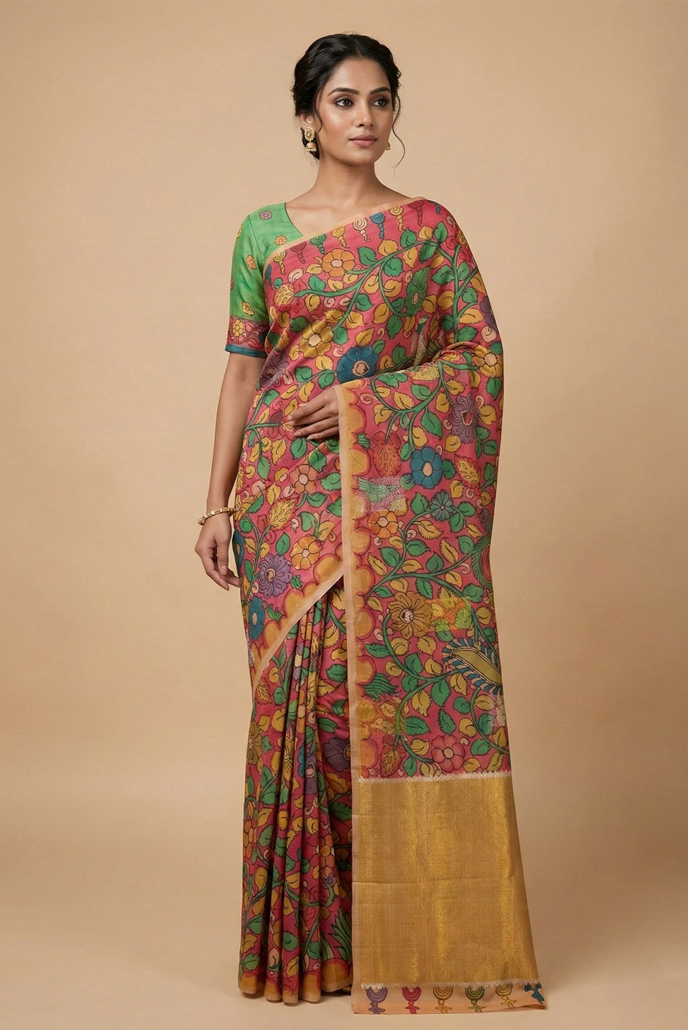 Model wearing a Coral Kanchipuram Silk Saree with kalamkari Print on the body and Fancy Border.