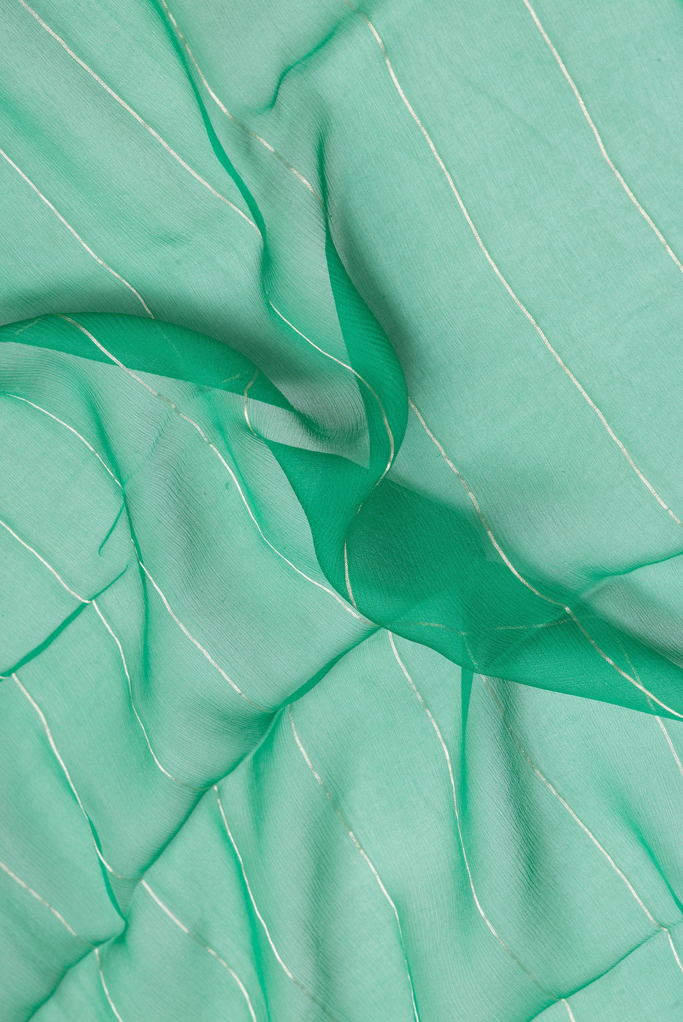 Close up of Green Mysore Chiffon Saree with Stripes on the body and Zari Border.  displaying folds