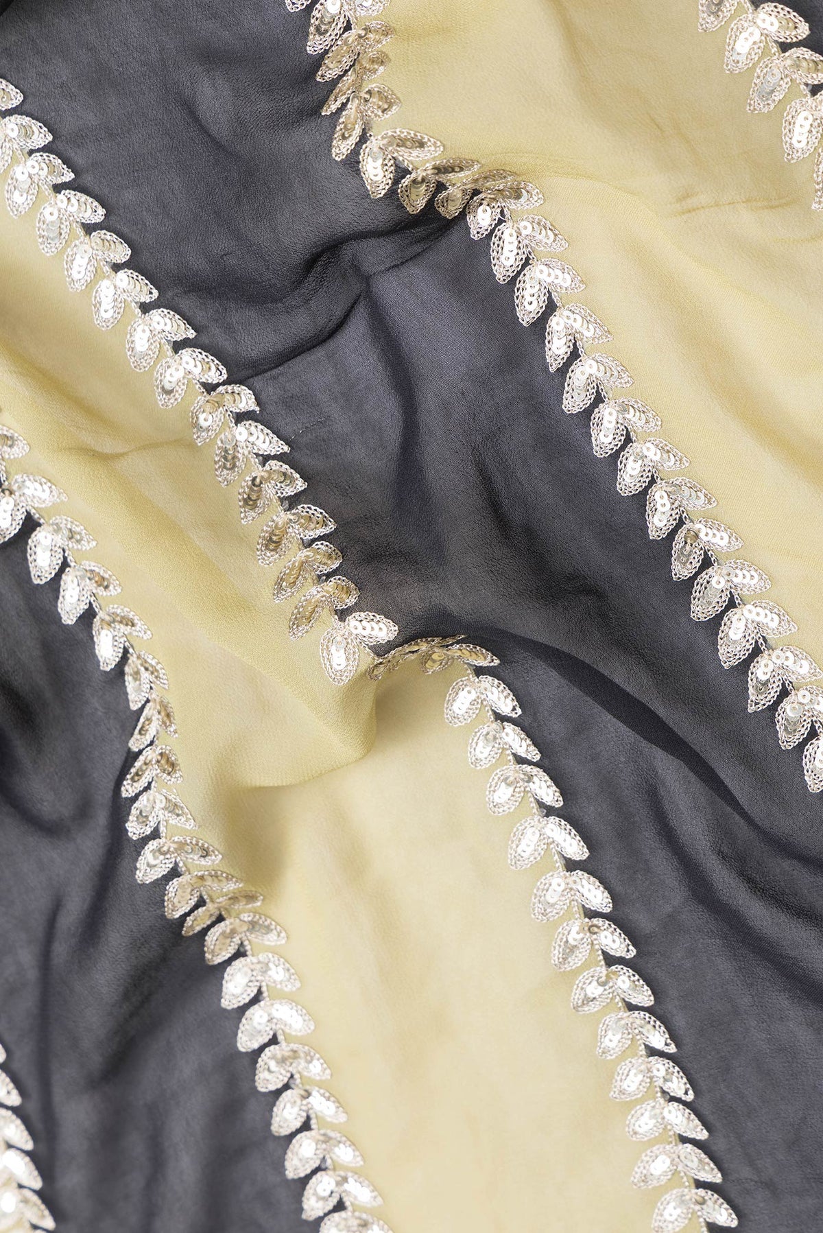 Close up of Green and Black Color Mysore Georgette Saree with Embroidery on the body and Embroidery Border.  displaying folds
