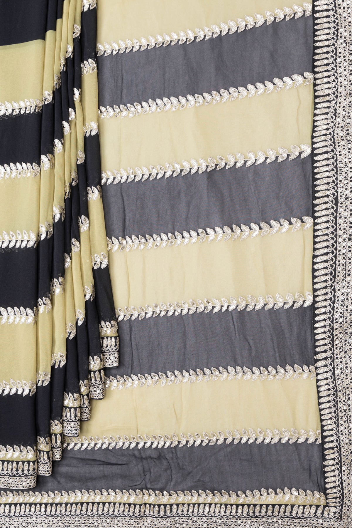 Pleats and pallu of Green and Black Color Mysore Georgette Saree with Embroidery on the body and Embroidery Border. 