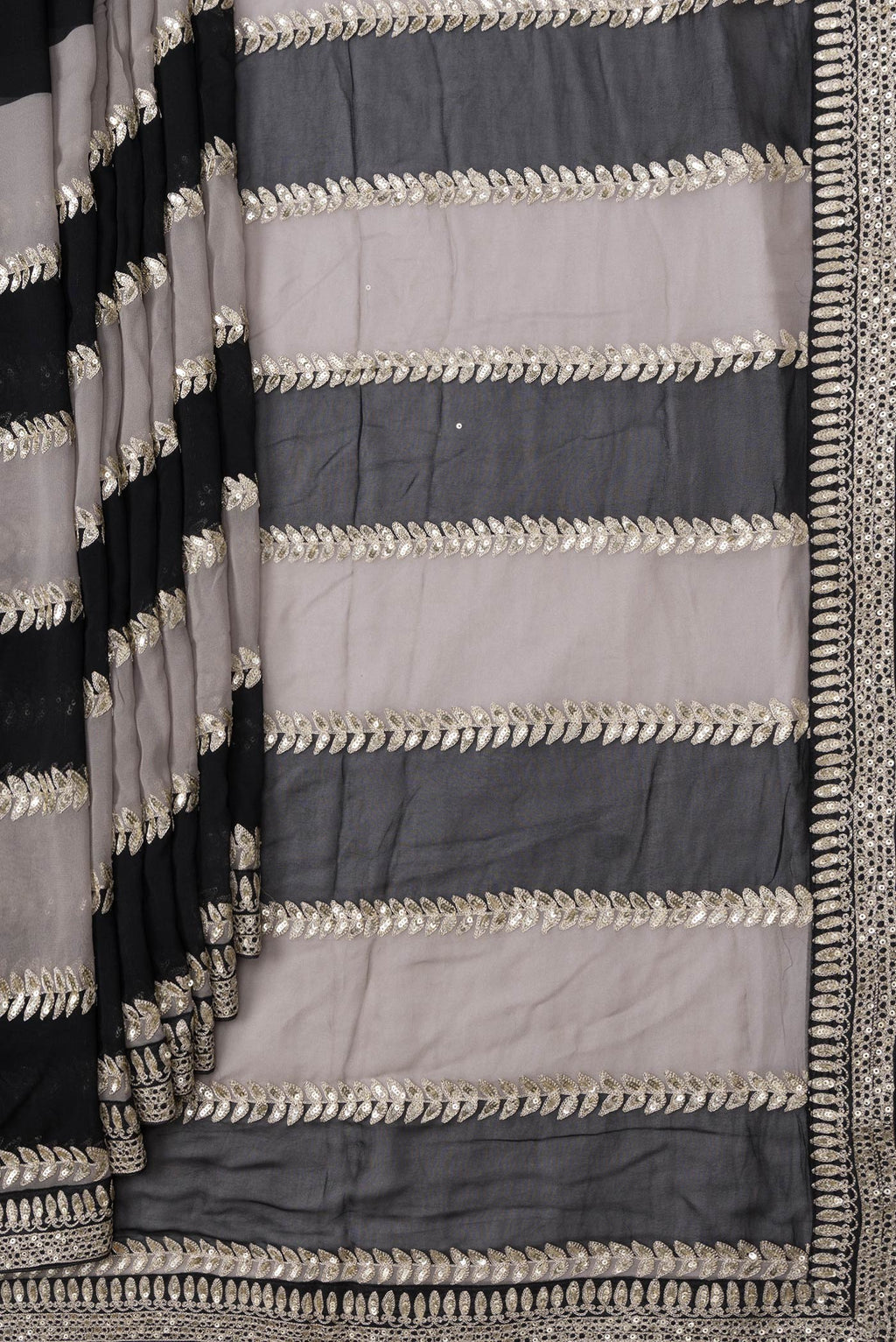 Pleats and pallu of Black Dual Tone Mysore Georgette Saree with Embroidery on the body and Embroidery Border. 