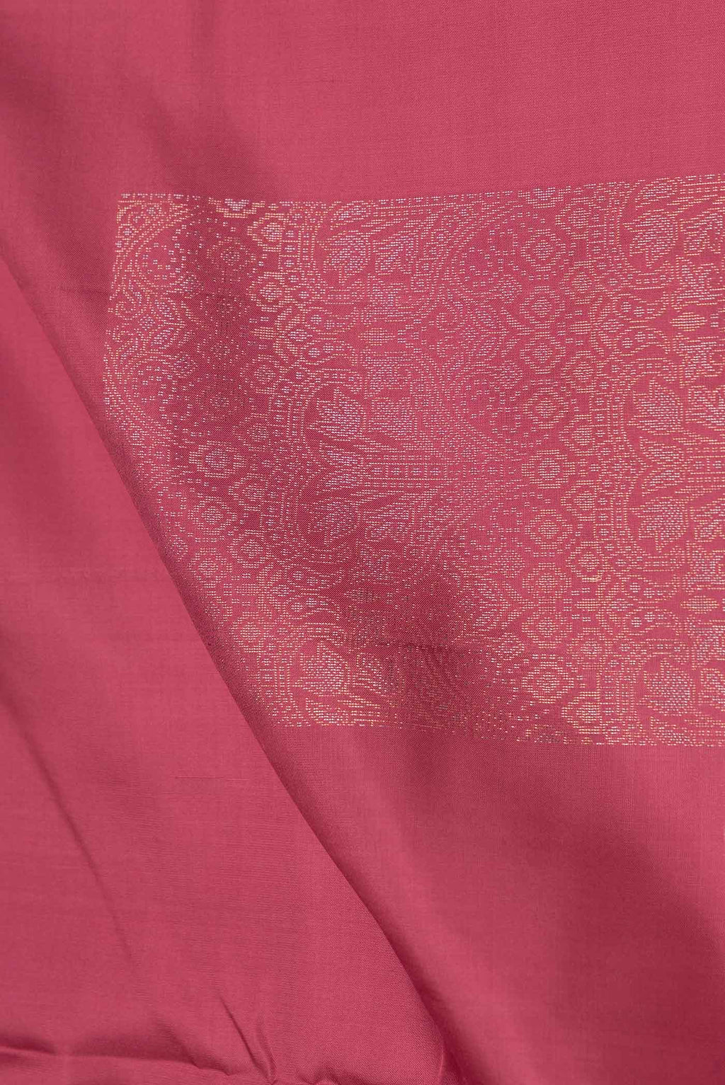 Close up of Pink Dual Tone Soft Silk Saree with Zari Butta on the body and Without Border.  displaying folds