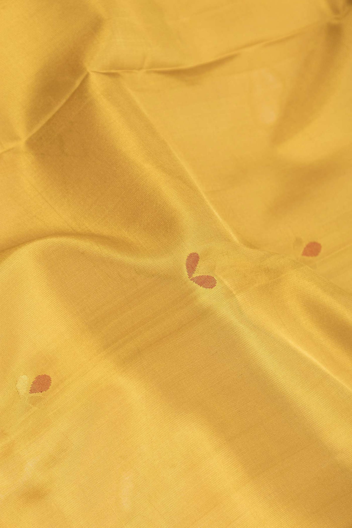 Close up of Mustard Dual Tone Uppada Silk Saree with Zari And Thread Butta on the body and Zari Border displaying folds