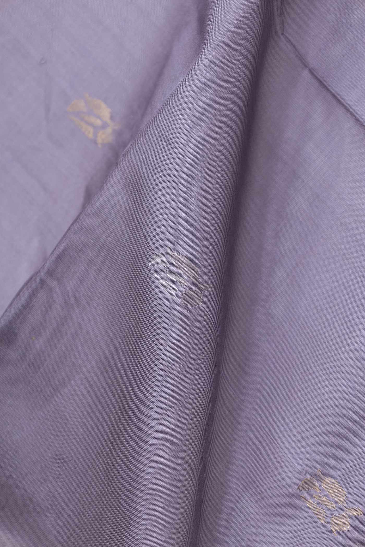 Close up of Grey Dual Tone Uppada Silk Saree with Zari Butta on the body and Zari Border displaying folds