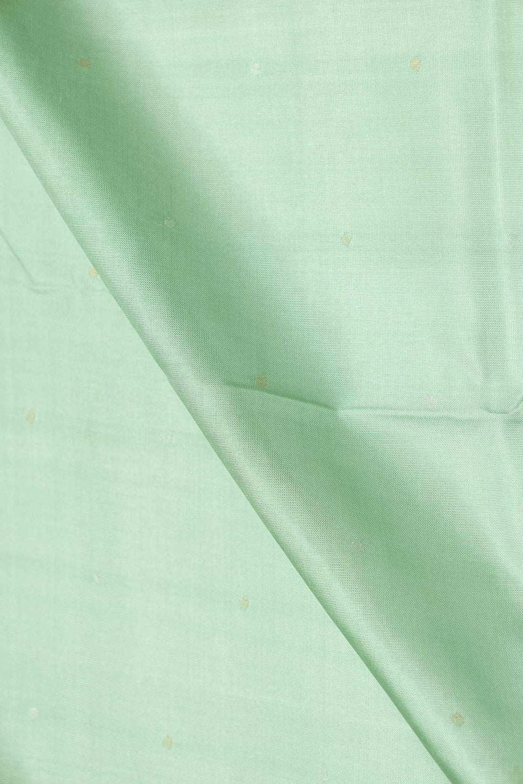 Close up of Pista Green Dual Tone Uppada Silk Saree with Zari Butta on the body and Zari Border displaying folds