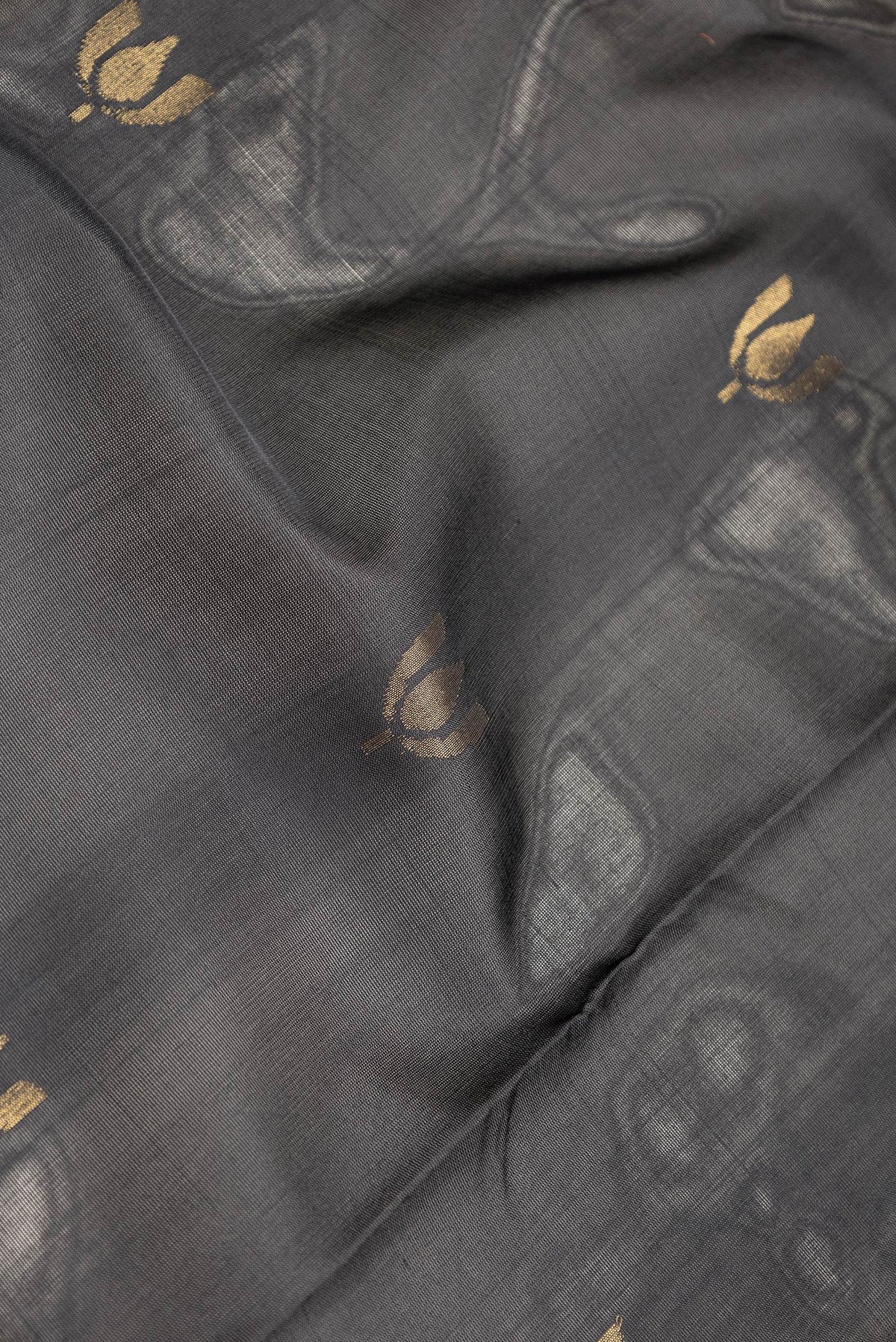 Close up of Black Dual Tone Uppada Silk Saree with Zari Butta on the body and Zari Border.  displaying folds