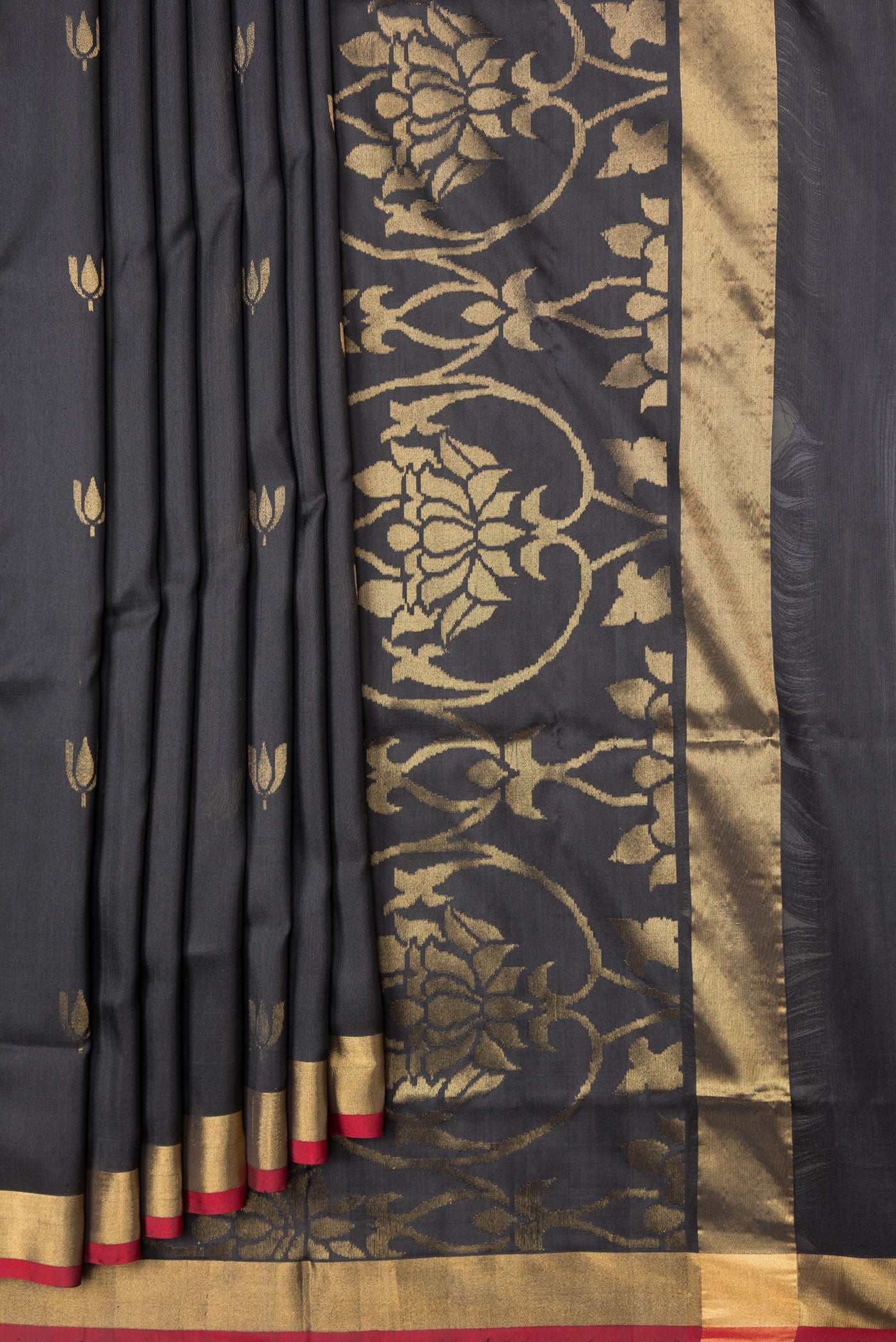 Pleats and pallu of Black Dual Tone Uppada Silk Saree with Zari Butta on the body and Zari Border. 