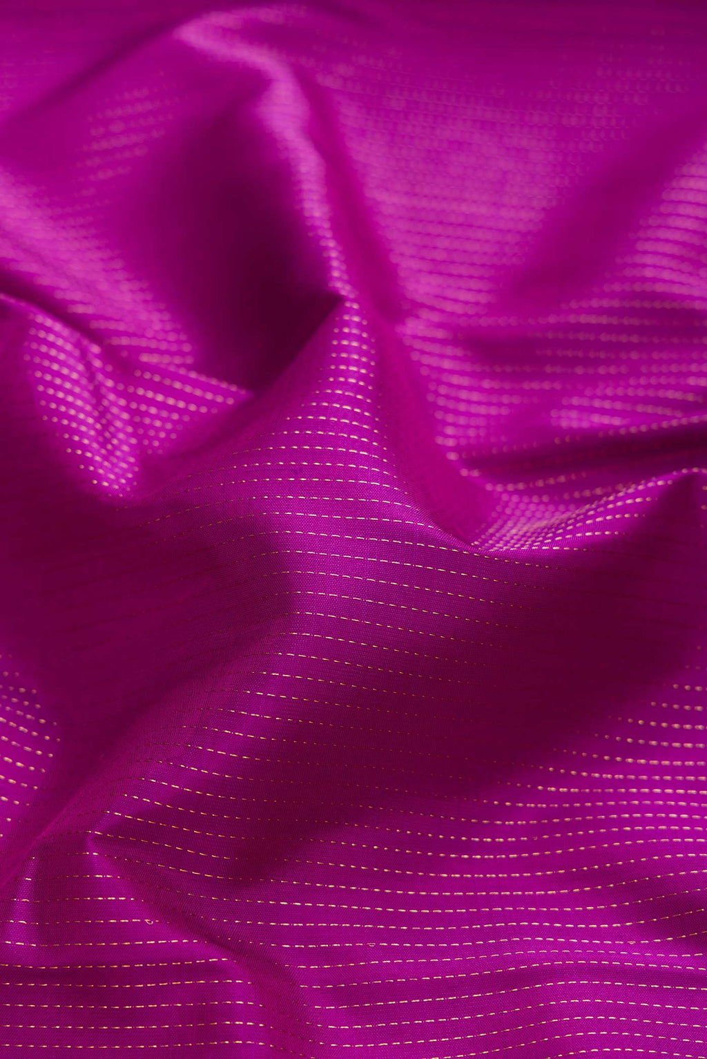 Close up of Magenta Dual Tone Kanchipuram Saree with Stripes on the body and Zari Border displaying folds