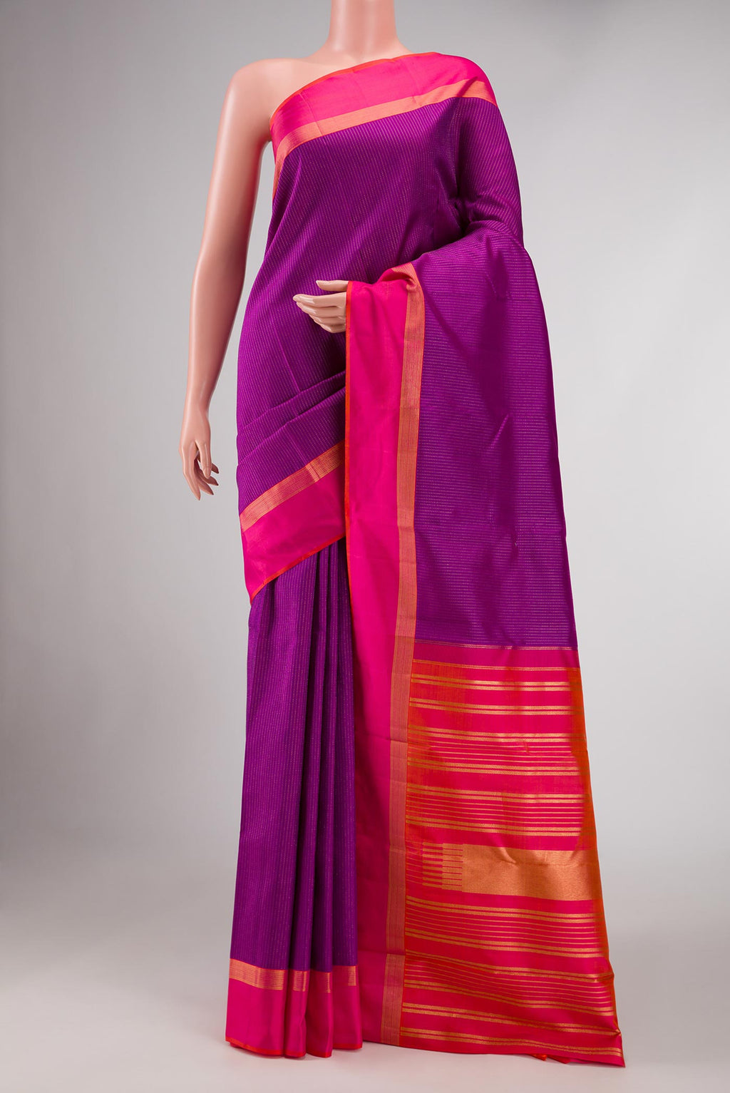 Magenta Dual Tone Kanchipuram Saree with Stripes on the body and Zari Border displayed on a mannequin