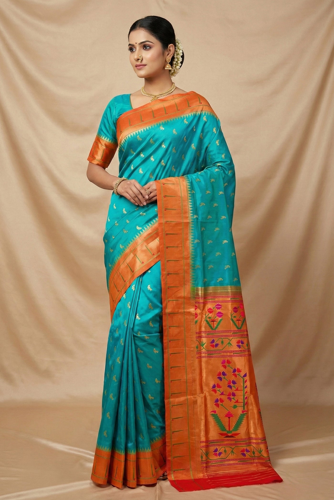 Model wearing a Blue Paithani Silk Saree with Zari Butta on the body and Paithani Border.