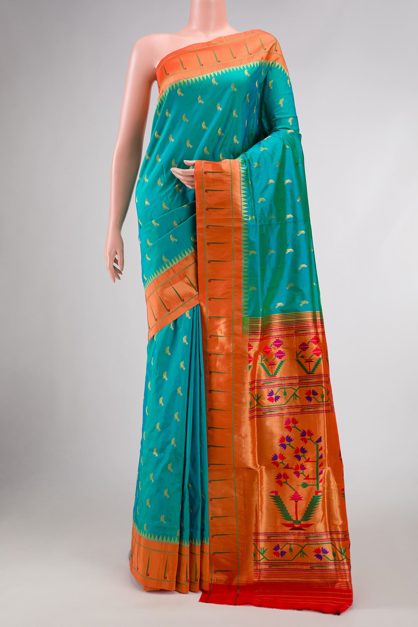 Green Dual Tone Paithani Silk Saree with Zari Butta on the body and Paithani Border.  displayed on a mannequin
