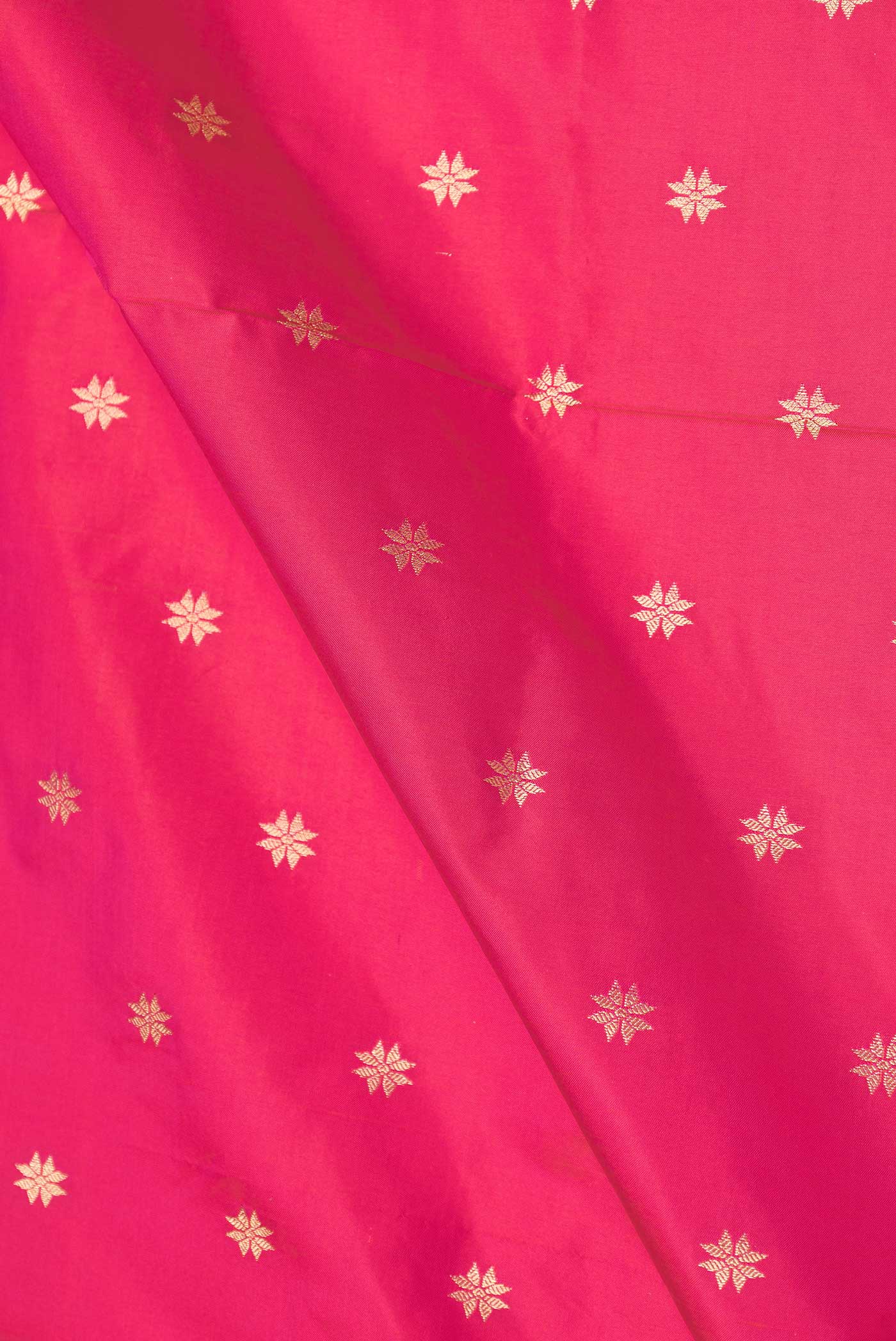 Close up of Pink Dual Tone Paithani Silk Saree with Zari Butta on the body and Paithani Border displaying folds