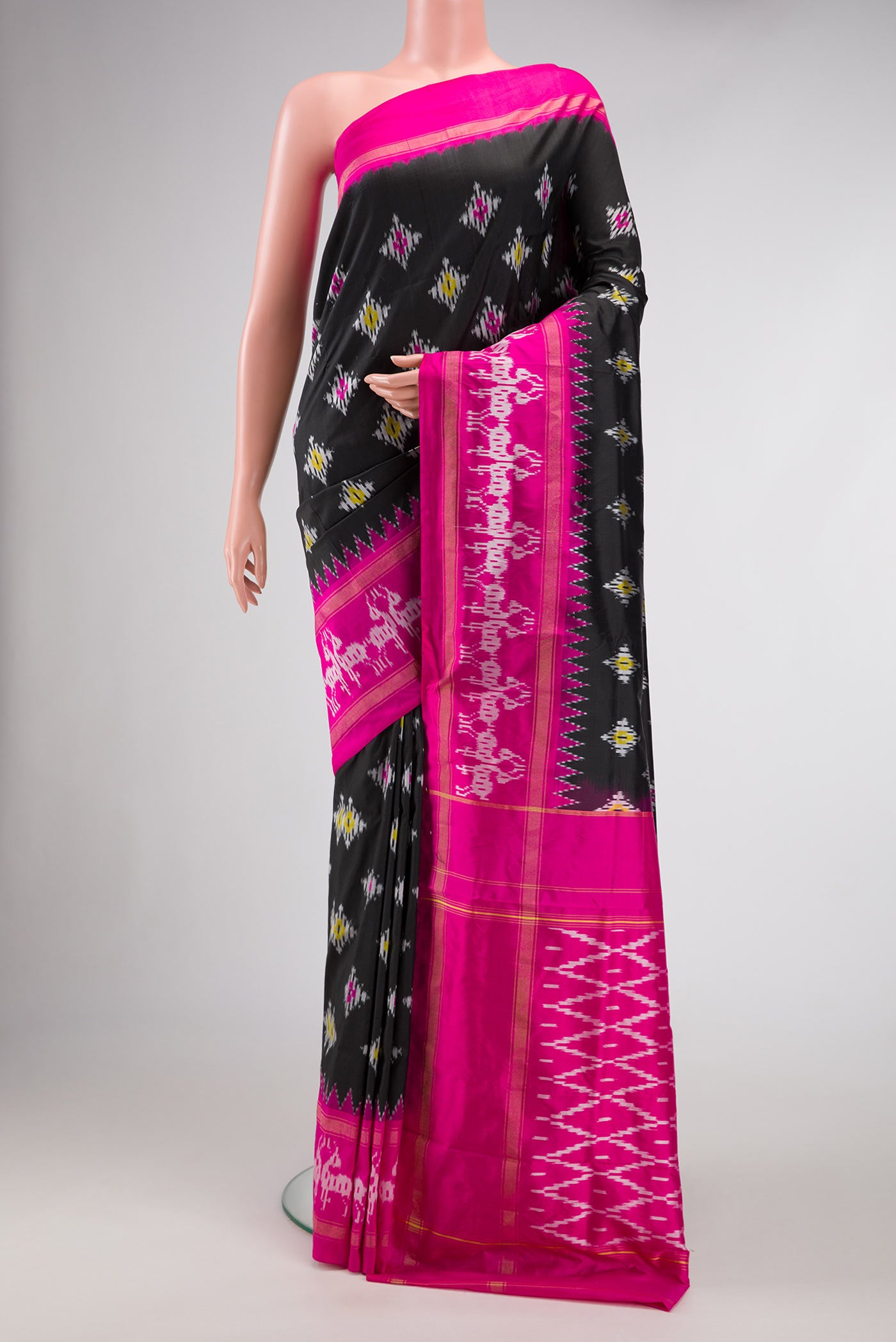 Black Dual Tone Double Ikat Saree with Ikat Print on the body and Ikat Border.  displayed on a mannequin