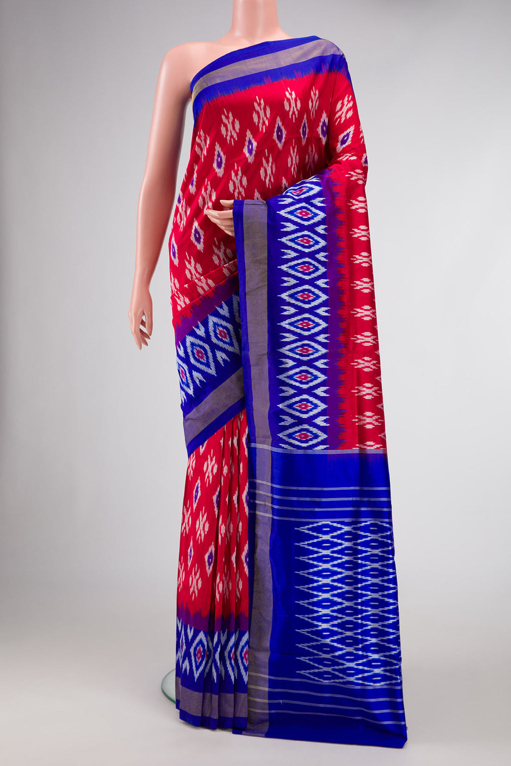 Red Dual Tone Double Ikat Saree with Ikat Print on the body and Ikat Border.  displayed on a mannequin