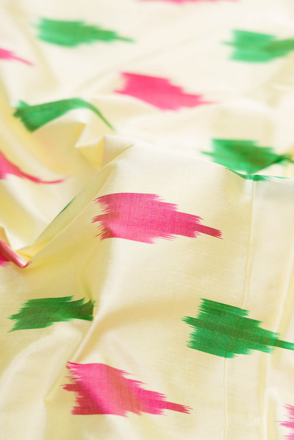 Close up of Sandal Dual Tone Double Ikat Saree with Ikat Print on the body and Ikat Border.  displaying folds