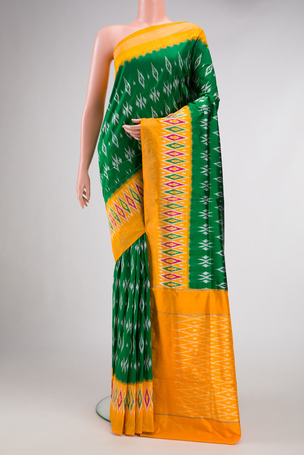 Green Dual Tone Double Ikat Saree with Ikat Print on the body and Ikat Border.  displayed on a mannequin
