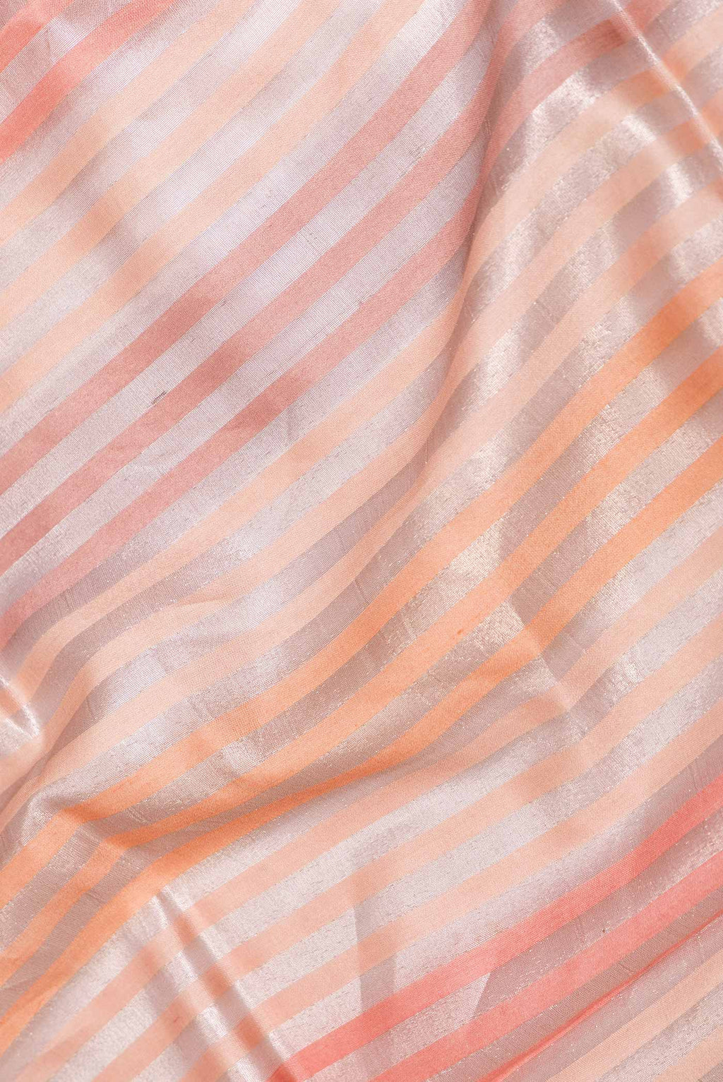 Close up of Golden Peach Dual Tone Banarasi Saree with Stripes on the body and Zari Border displaying folds