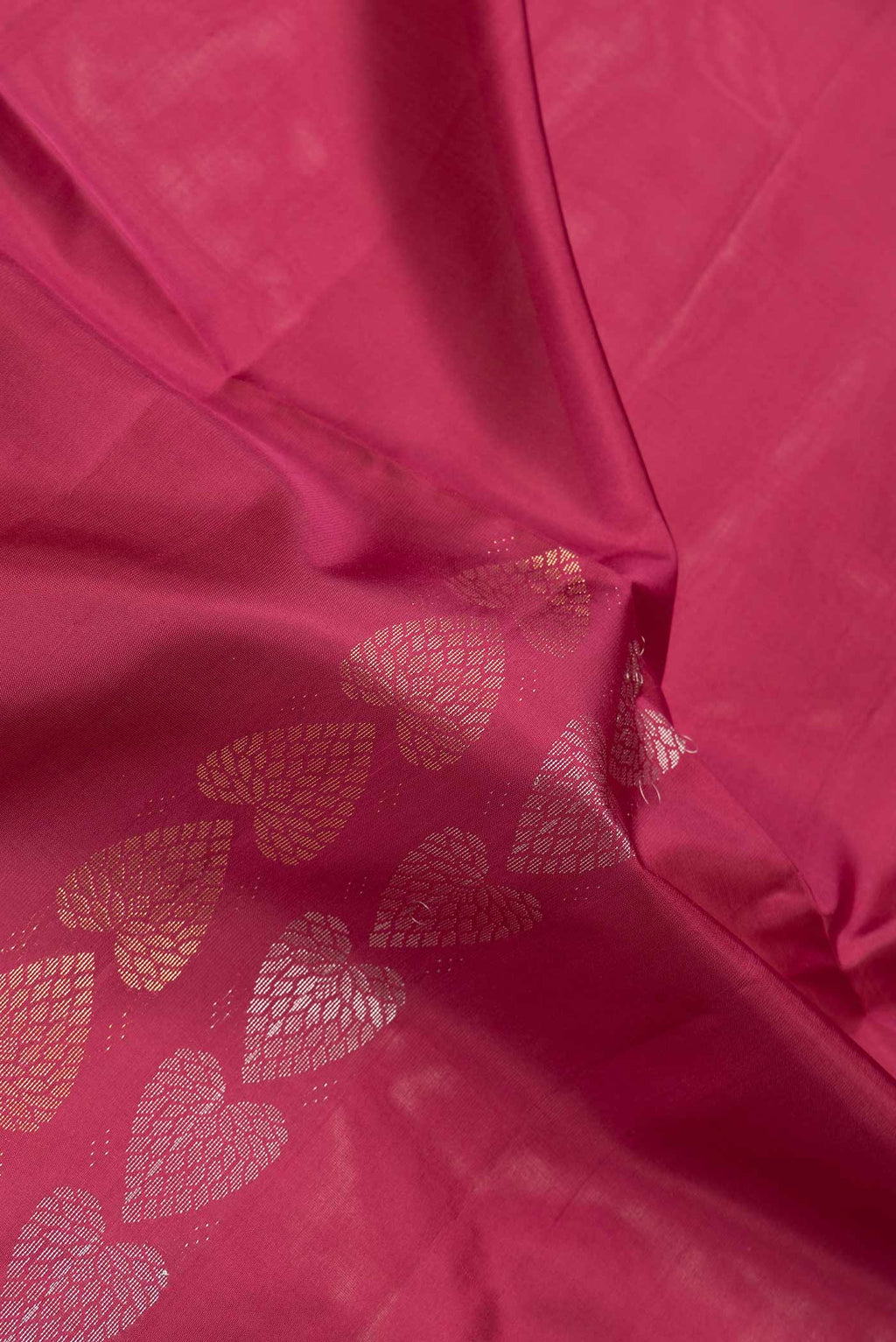 Close up of Maroon Dual Tone Soft Silk Saree with Zari Butta on the body and Without Border.  displaying folds