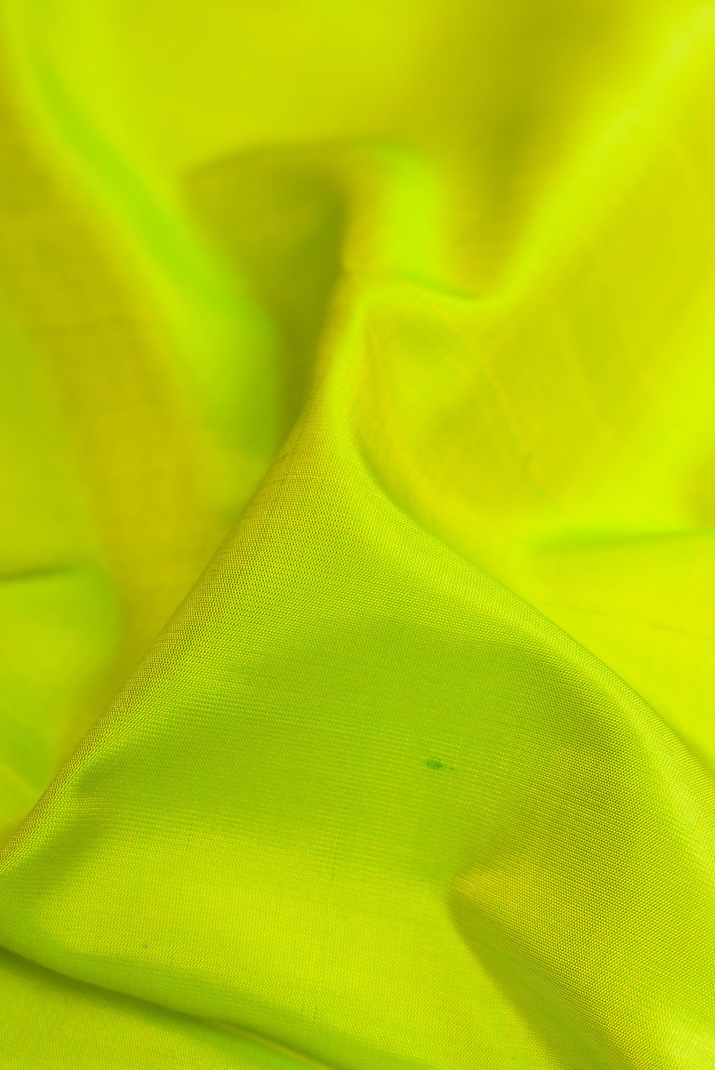 Close up of Parrot Green Soft Silk Saree with Plain Body and Fancy Border.  displaying folds
