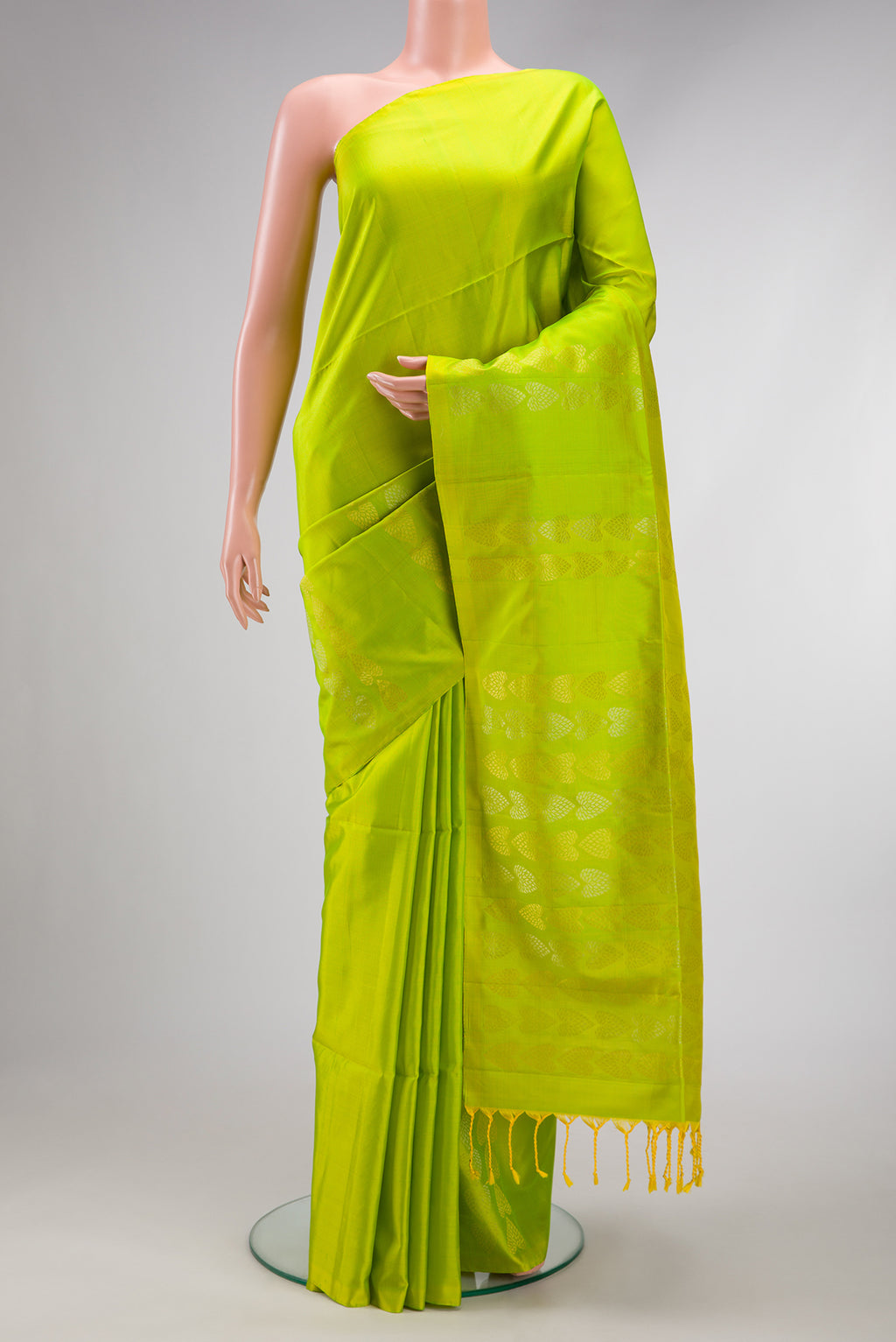 Parrot Green Soft Silk Saree with Plain Body and Fancy Border.  displayed on a mannequin