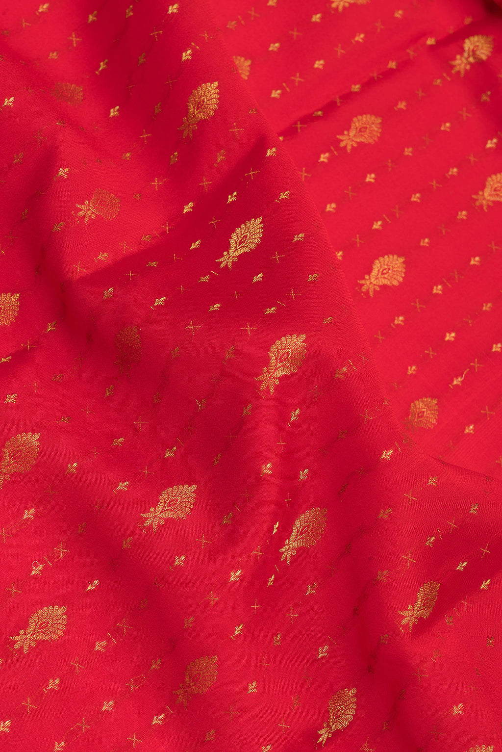 Close up of Red Mysore Silk Saree with Zari Butta on the body and Zari Border.  displaying folds