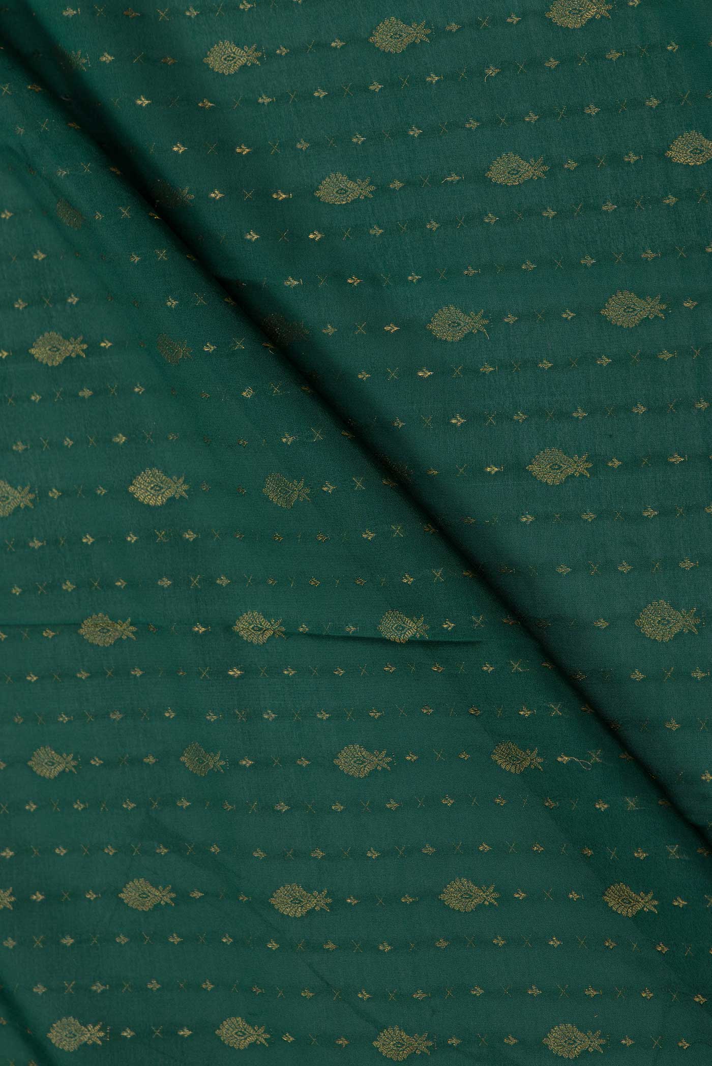 Close up of Green Dual Tone Mysore Crepe Saree with Zari Butta on the body and Zari Border displaying folds
