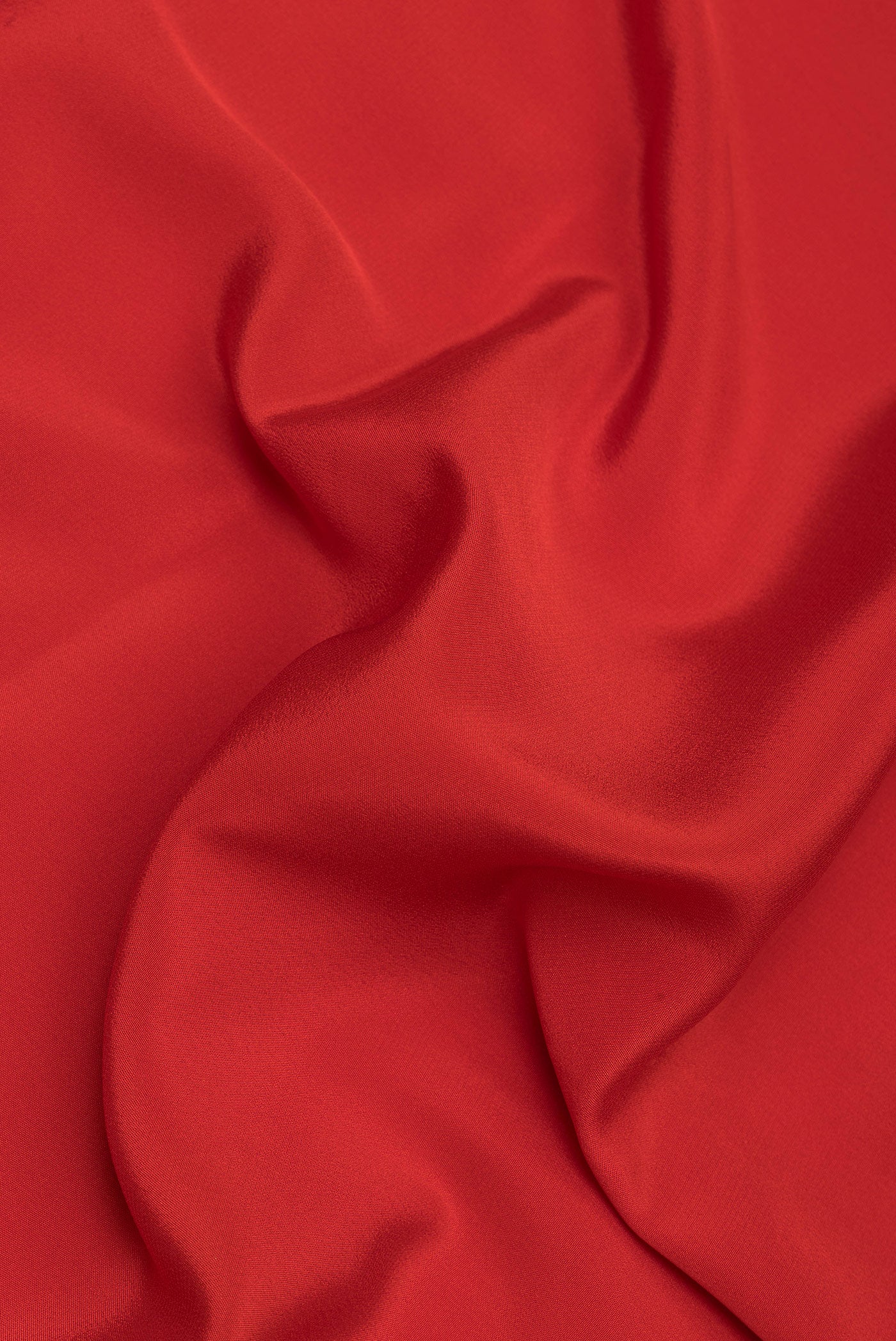 Close up of Red Mysore Silk Saree with Plain Body and Zari Border.  displaying folds