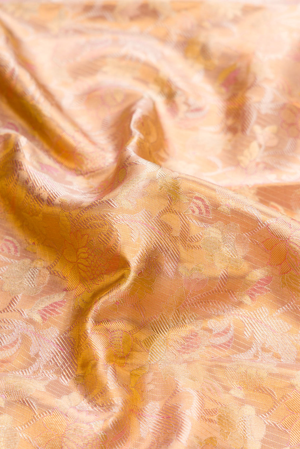Close up of Rose Gold Dual Tone Kanchipuram Tissue Silk Saree with Zari Brocade on the body and Zari Border.  displaying folds