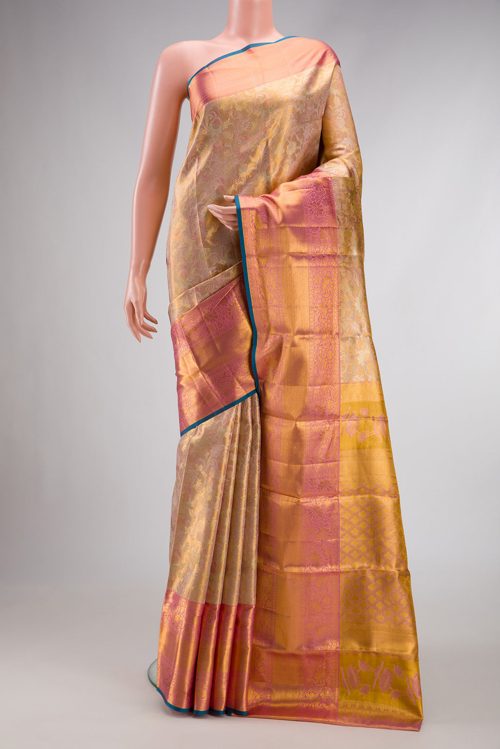 Rose Gold Dual Tone Kanchipuram Tissue Silk Saree with Zari Brocade on the body and Zari Border.  displayed on a mannequin