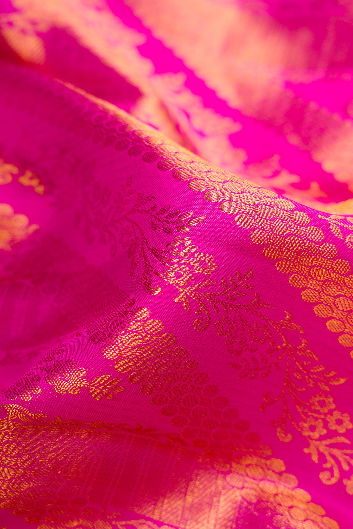 Close up of Pink Dual Tone Kanchipuram Silk Saree with Zari Brocade on the body and Zari Border.  displaying folds