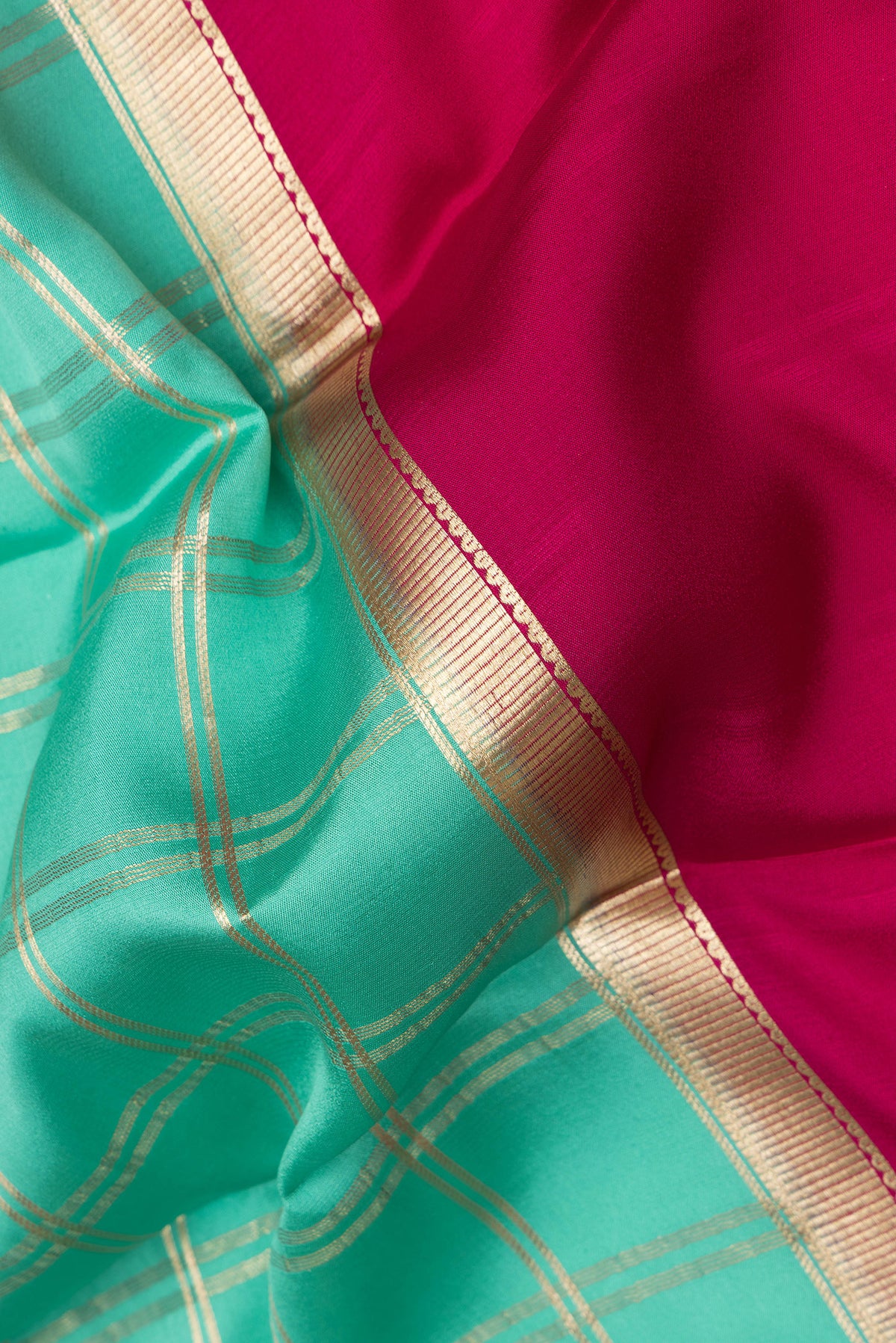 Close up of Sea Green Dual Tone Mysore Crepe Saree with Checked design on the body and Zari Border.  displaying folds